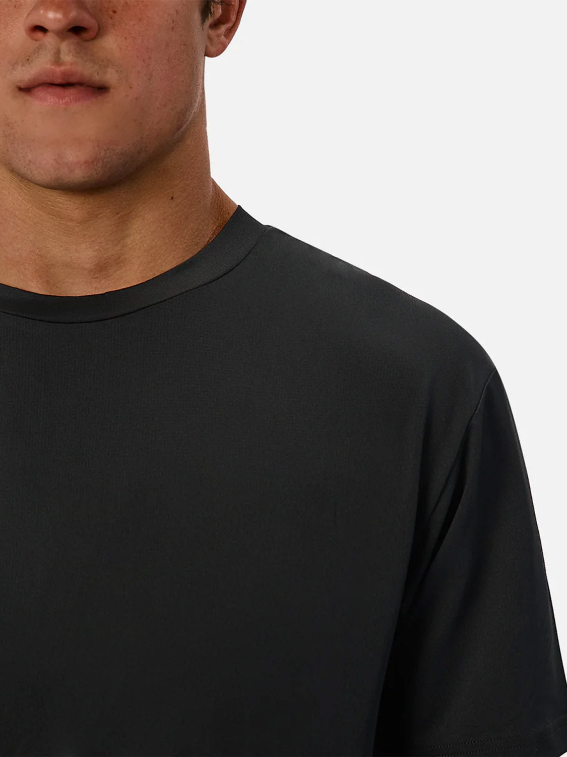 A close-up shows a person wearing the Industrie Boldon T-Shirt in black, pictured from the shoulders to just above the mouth against a light grey background.
