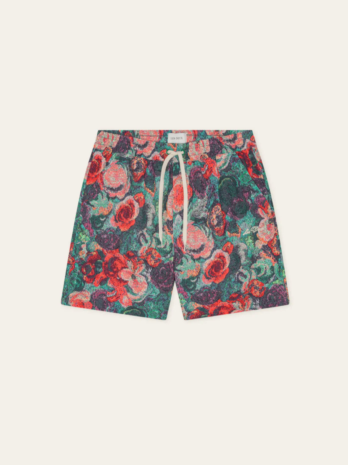 Les Deux Bouquet AOP Swim Shorts feature a drawstring waist and an all-over abstract floral pattern in red, green, purple, and orange on a light background.