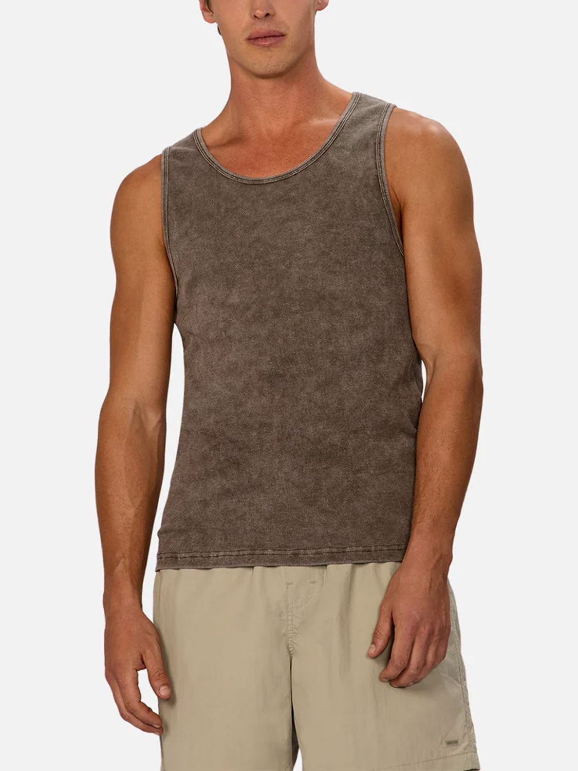 A man models the Industrie Washed Brando Ribbed Tank Top in brown, paired with light beige shorts against a plain background. With a relaxed stance and tilted head, this tank is an ideal choice for any summer wardrobe.