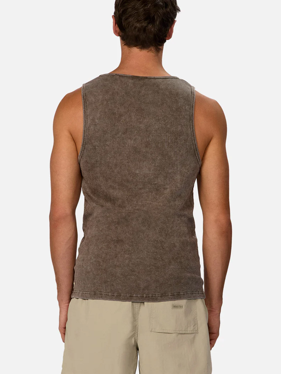A man is seen from behind wearing the Industrie Washed Brando Ribbed Tank Top in faded brown and light beige shorts, set against a plain light background—an ideal summer look.