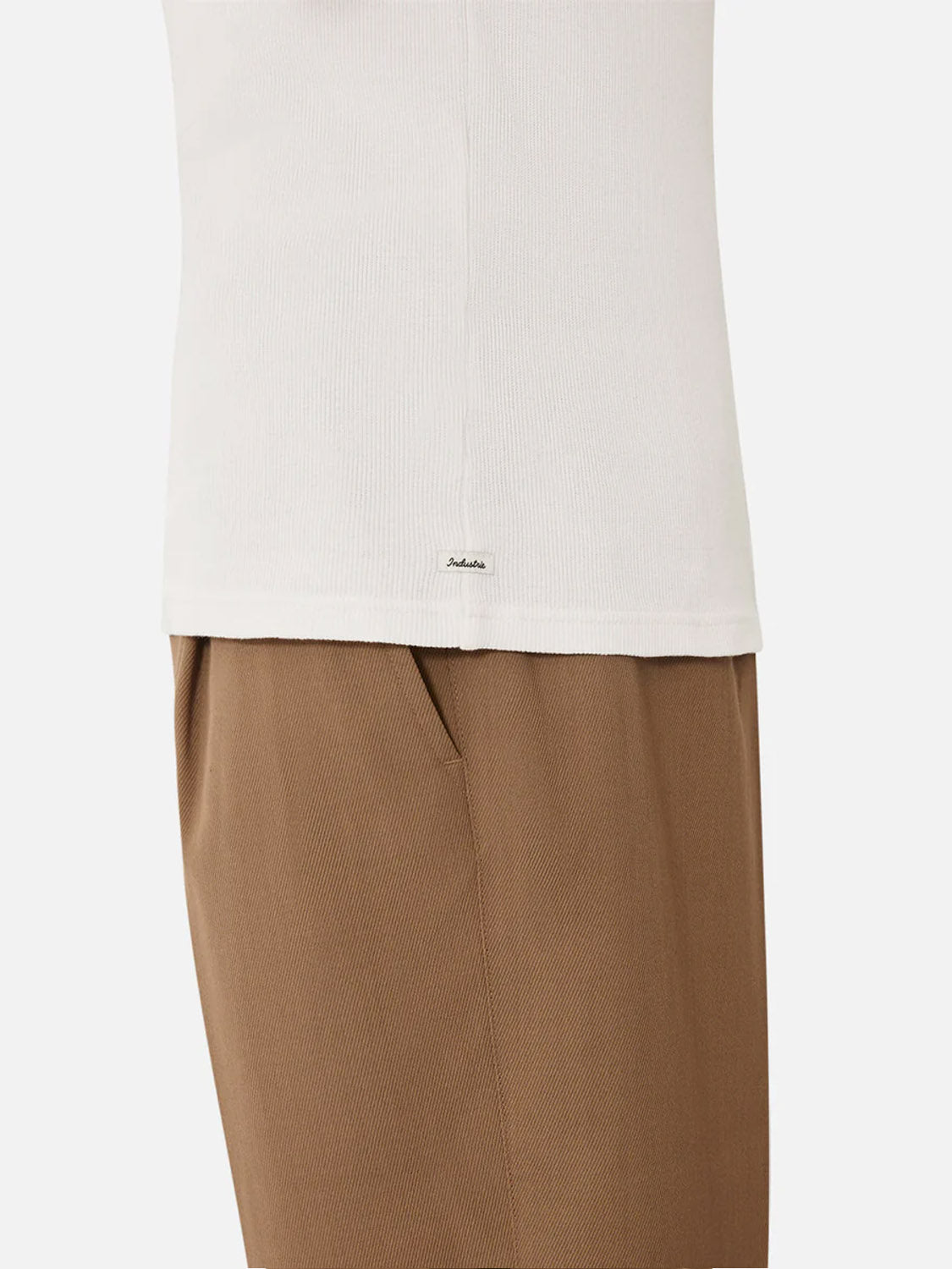 A person wears the Industrie Washed Brando Ribbed Tank Top—a slim fit, white ribbed shirt—paired with light brown pants, shown from the waist down against a plain white background; perfect for any summer wardrobe.