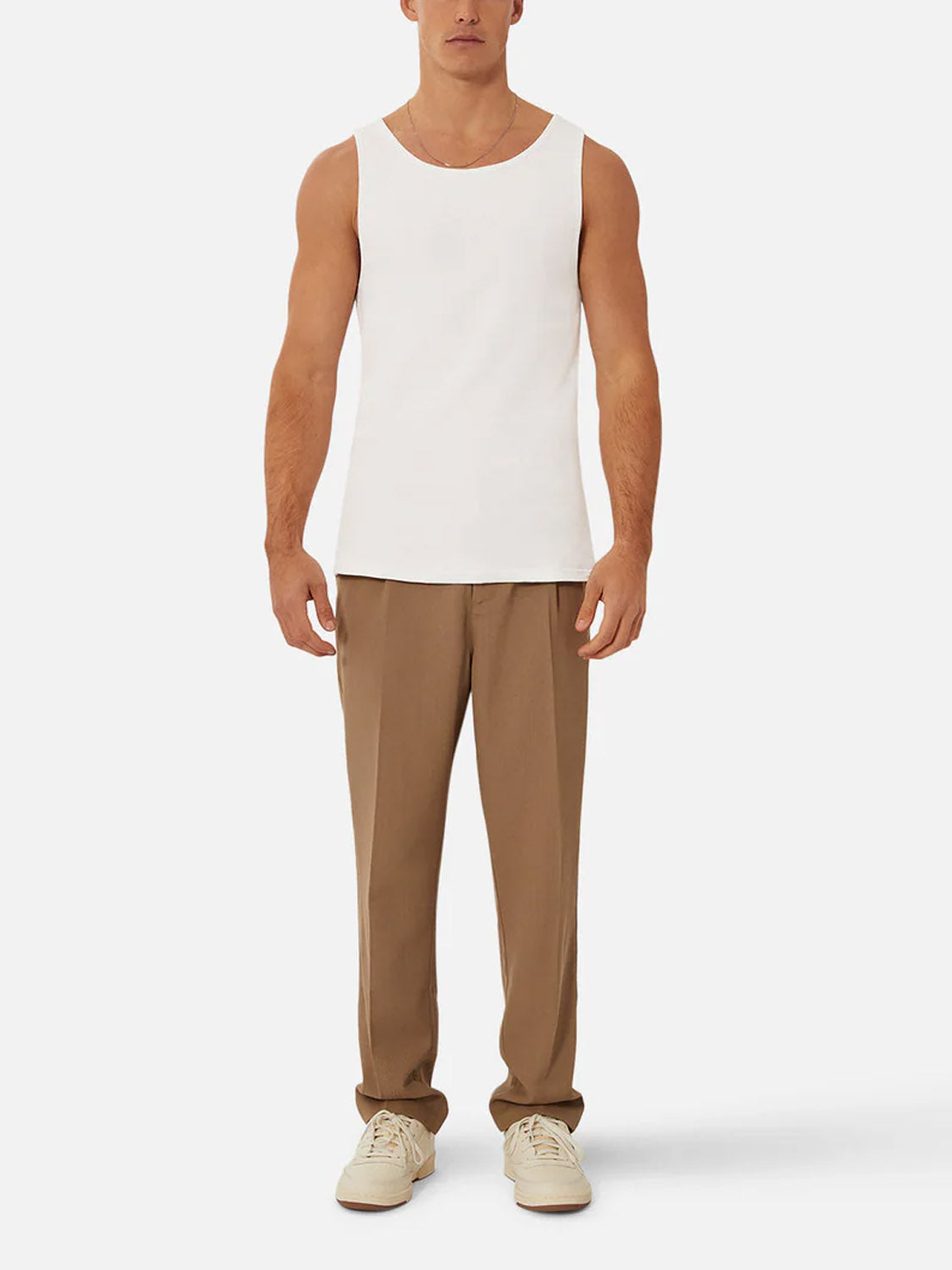 A man faces forward in the Industrie Washed Brando Ribbed Tank Top, paired with light brown trousers and beige sneakers—an easy summer look set against a plain white background.