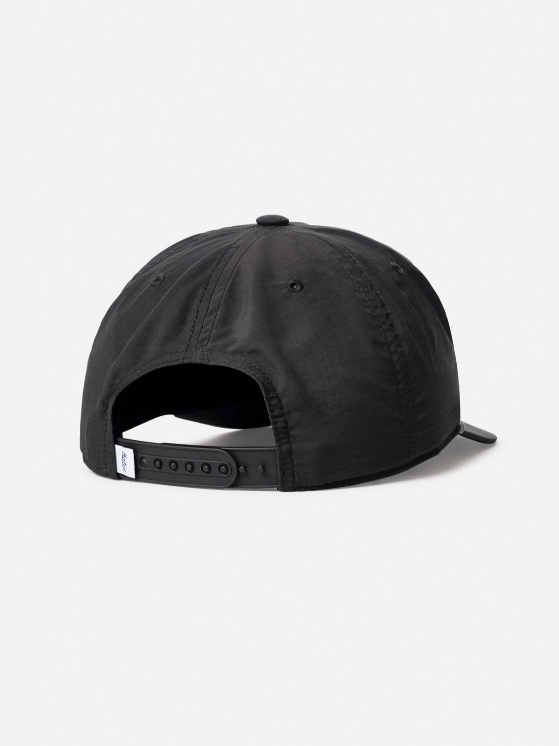 The Katin Breach Hat, made from black recycled nylon, is displayed from the back with an adjustable snapback and a small white tag by the closure, set against a plain white background.