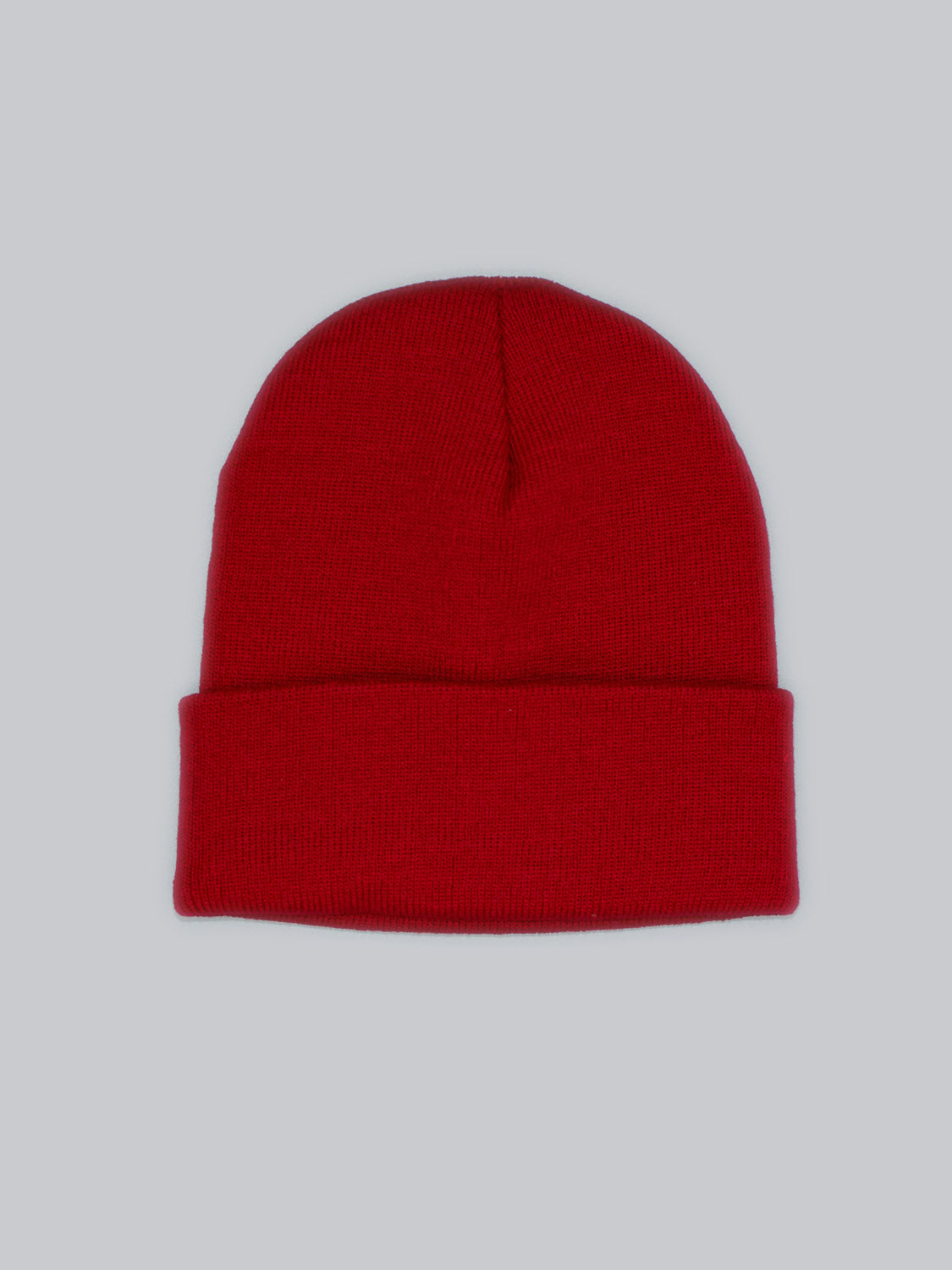 An ID Menswear Bronx Acrylic Beanie in vibrant red, featuring a folded brim and stretchable design, is set against a light gray background.