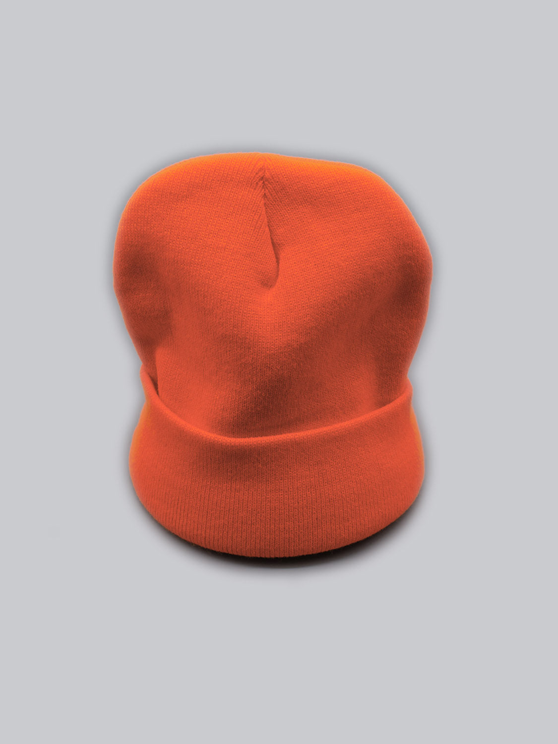 The Bronx Acrylic Beanie by ID Menswear, made of durable acrylic, features a stretchable design for a perfect fit and stands out against a plain gray background.