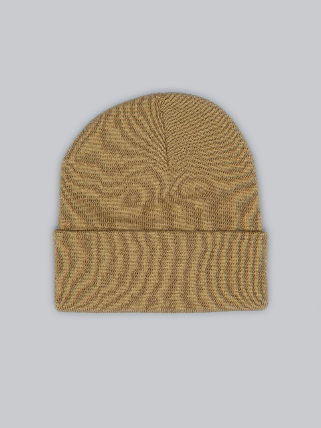 The Bronx Acrylic Beanie by ID Menswear, made from soft acrylic with a knit texture, is light brown with a folded brim. Presented on a light gray background, its stretchable design ensures comfort for everyone.