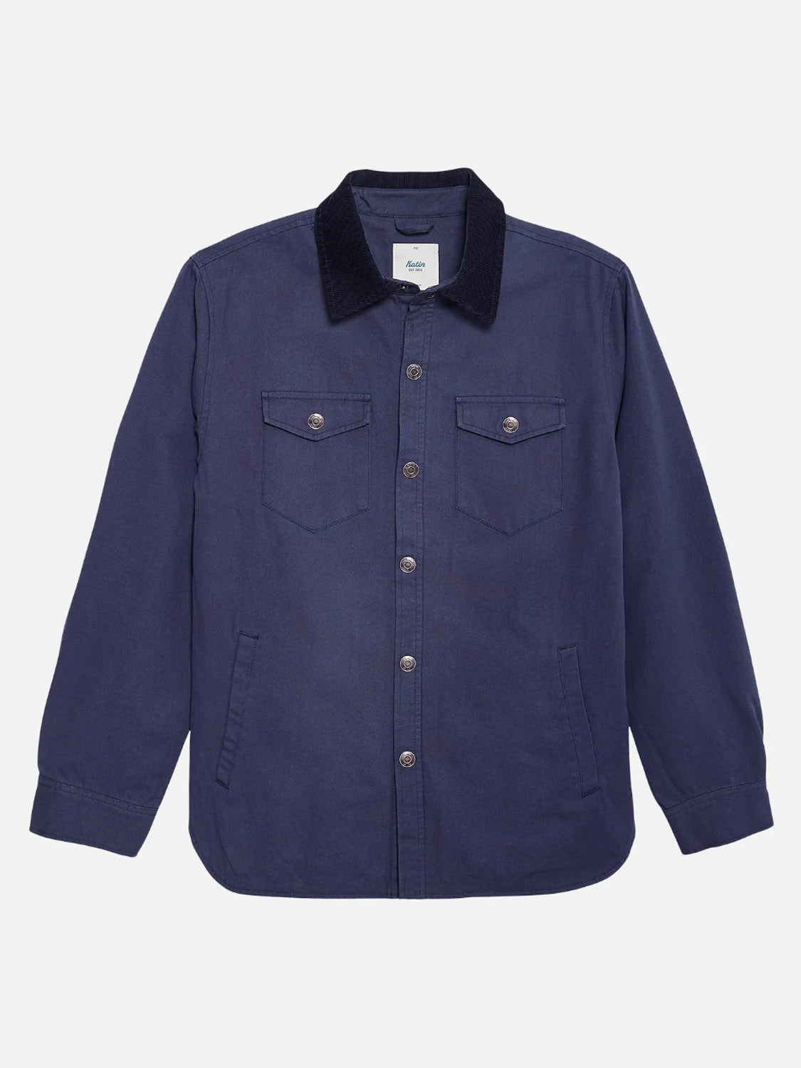 The Katin Campbell Jacket is a dark blue, button-up shirt jacket made from durable cotton canvas. It features long sleeves, two chest pockets with buttoned flaps, metallic buttons, and a corduroy collar, all displayed flat on a white background.