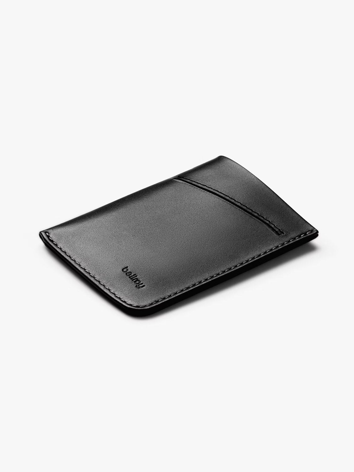 The Bellroy Card Sleeve Wallet is a slim black minimalist wallet featuring one diagonal card slot and subtle edge stitching, shown on a plain light gray background.