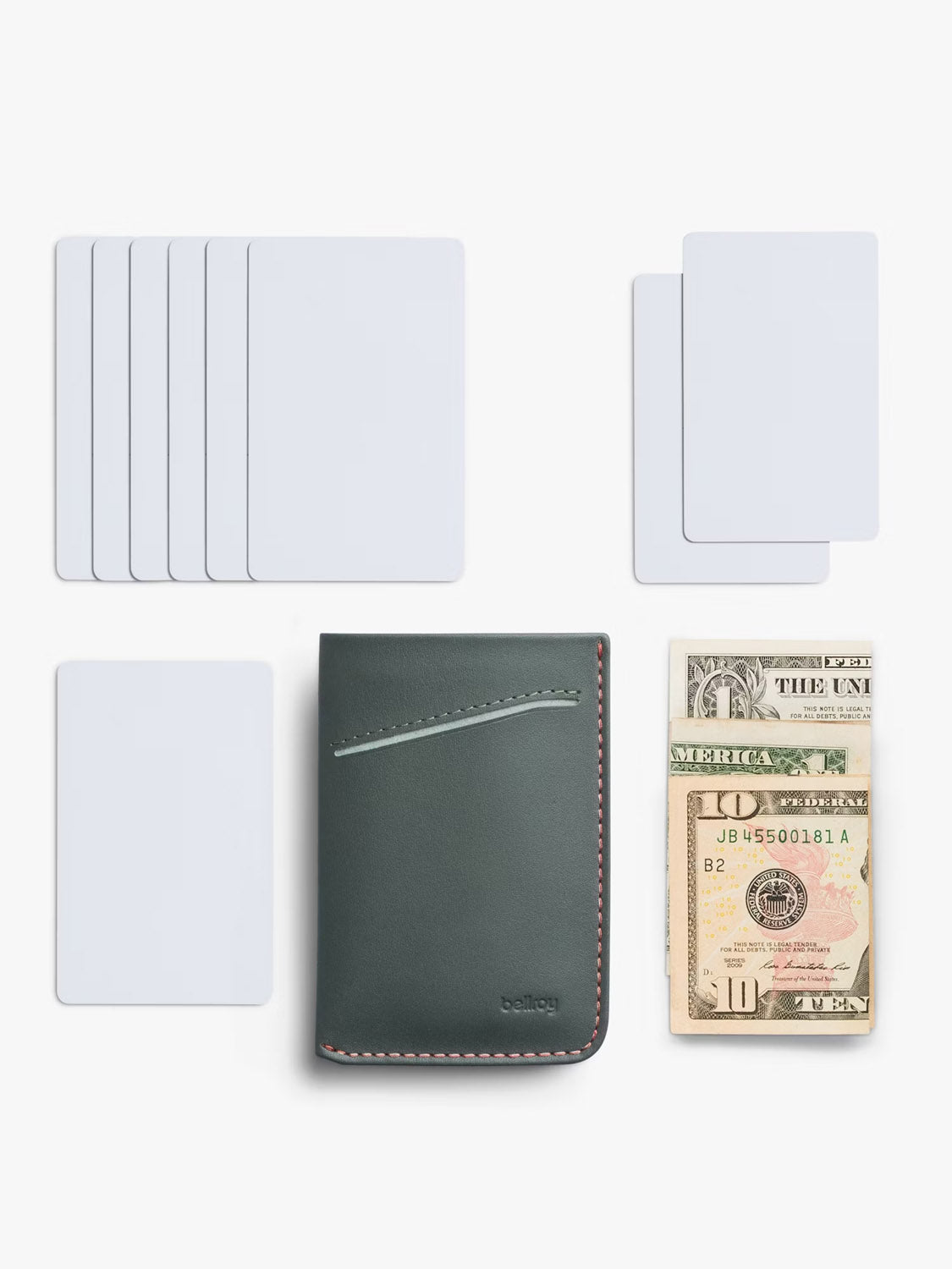 The Bellroy Card Sleeve Wallet, a sleek green minimalist leather card holder with a front slot, is shown closed on a white background beside blank cards and folded US dollar bills.