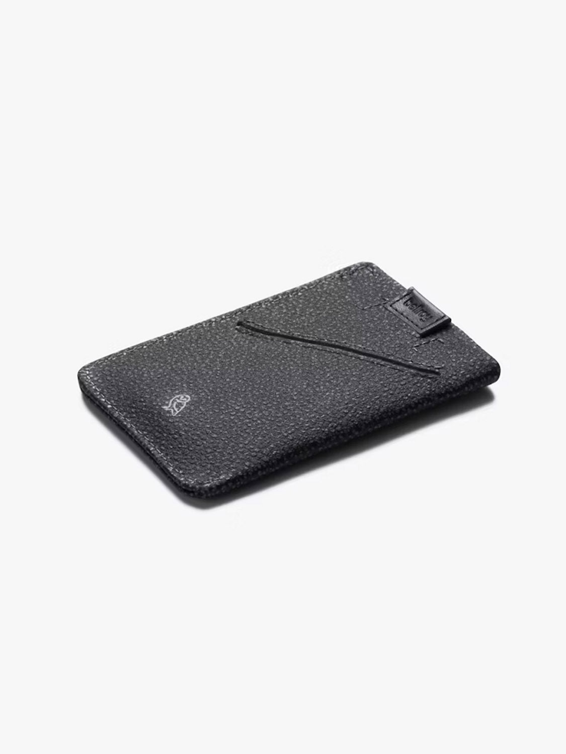 The Bellroy Card Sleeve Wallet is a slim black premium leather wallet with a textured finish, featuring an angled card slot and a subtle embossed logo, displayed on a light background.