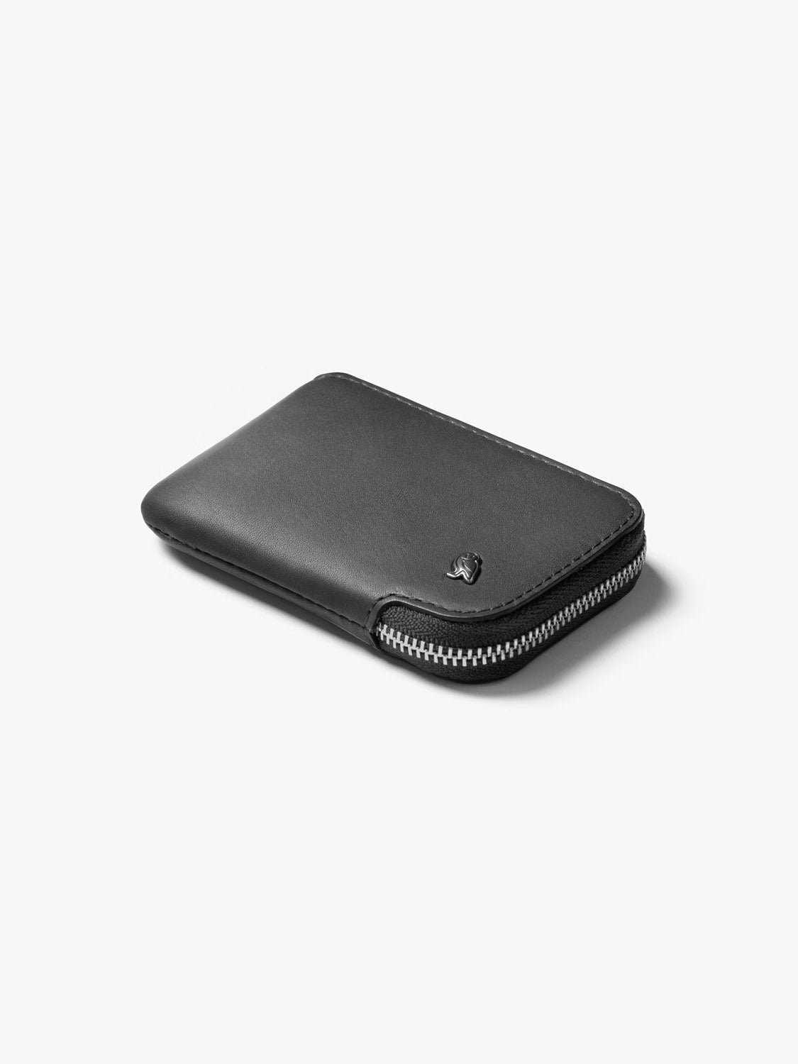 The Bellroy Card Pocket Wallet, shown on a light background, features smooth black leather, a subtle embossed logo, and a silver zipper along the edge. Its versatile design includes an integrated coin pouch for added convenience.