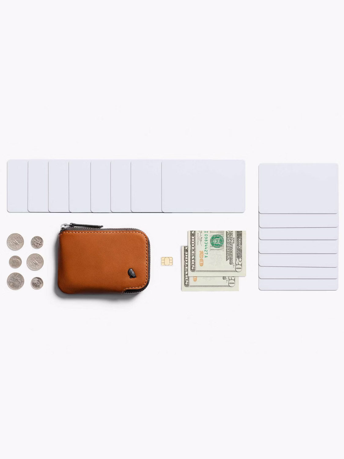A Bellroy Card Pocket Wallet in brown leather, shown on a white background, is displayed with coins, a SIM card, blank card holders, and folded cash neatly arranged beside it.