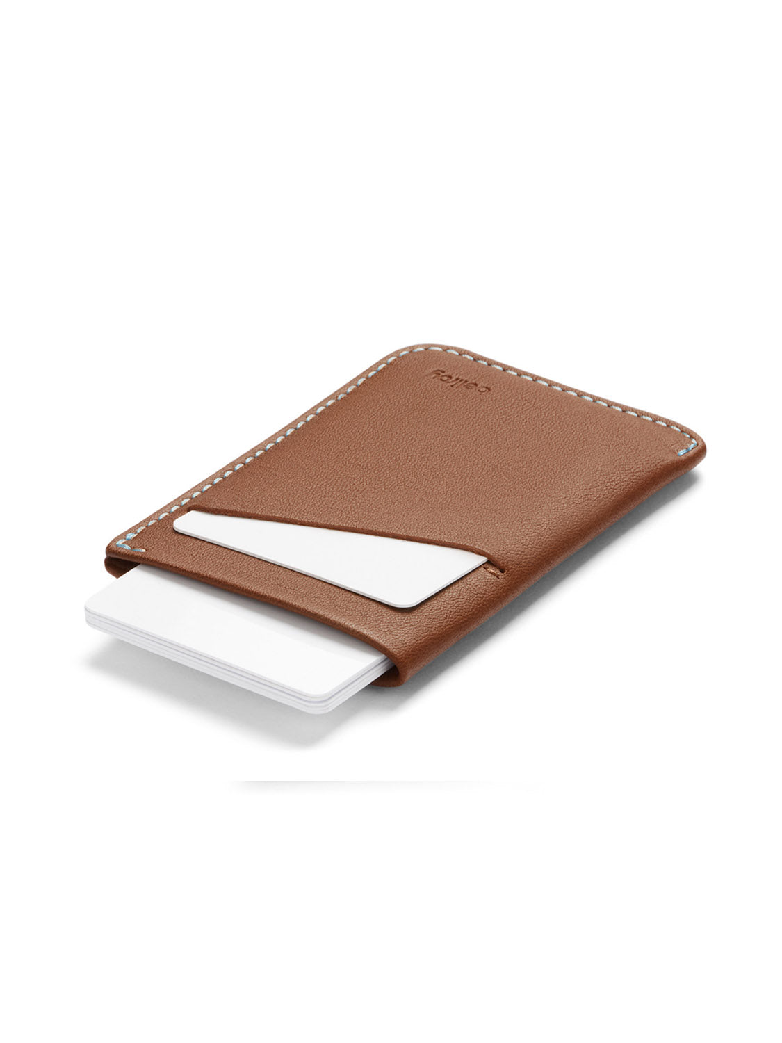 The Bellroy Card Sleeve Wallet is a slim brown leather holder with white stitching, featuring main and front pockets that show several white cards. The minimalist design is displayed against a white background.