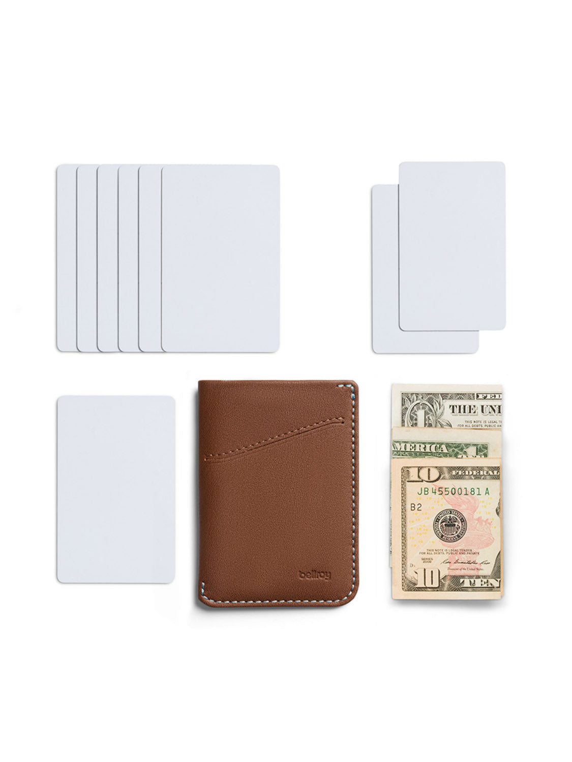 The Bellroy Card Sleeve Wallet, shown in brown, is placed on a white background alongside blank cards and a folded stack of U.S. dollar bills.