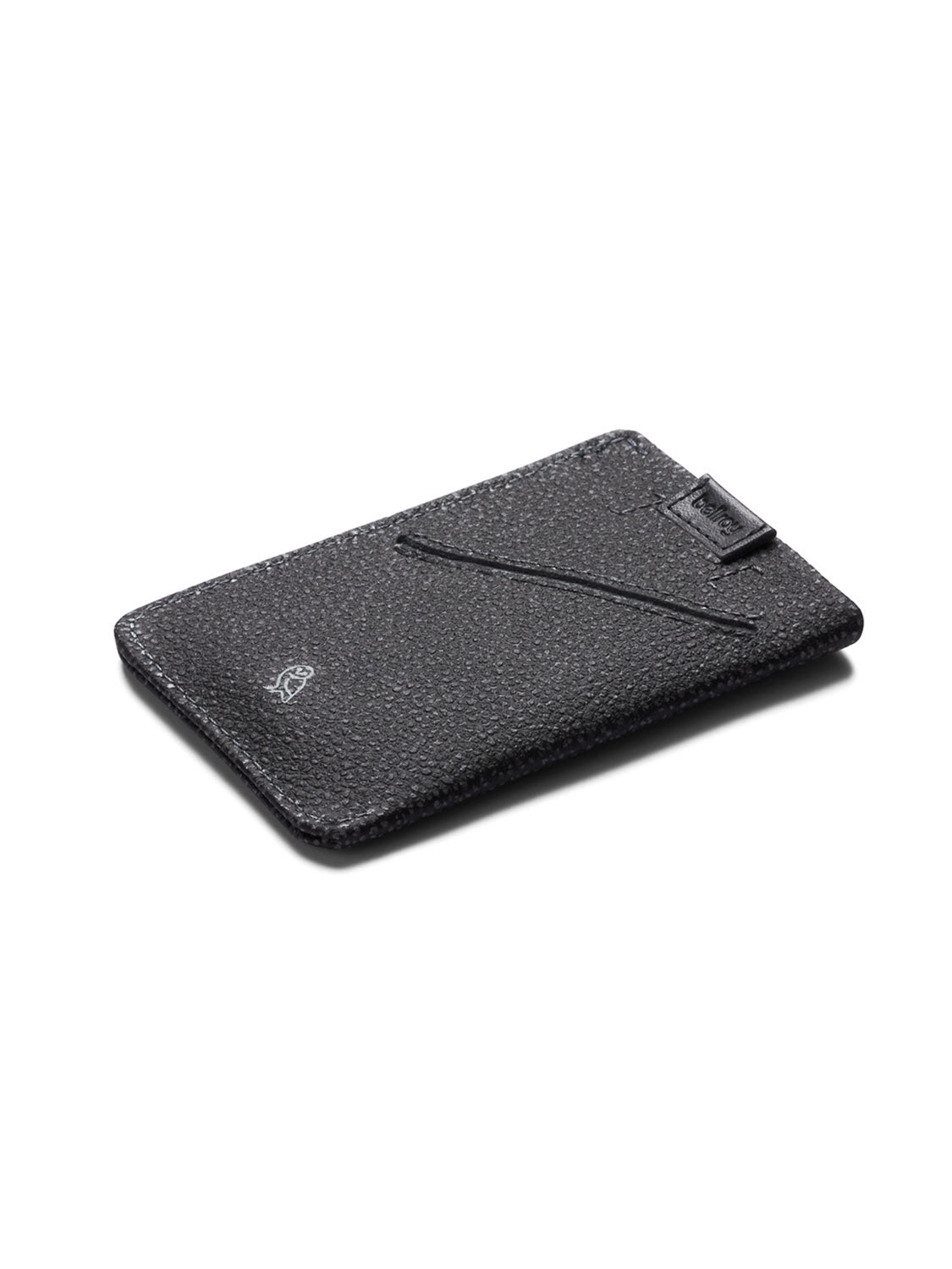 The Bellroy Card Sleeve Wallet is a slim, black textured leather card holder featuring a diagonal slot and a small embossed logo in the lower corner, shown against a white background.