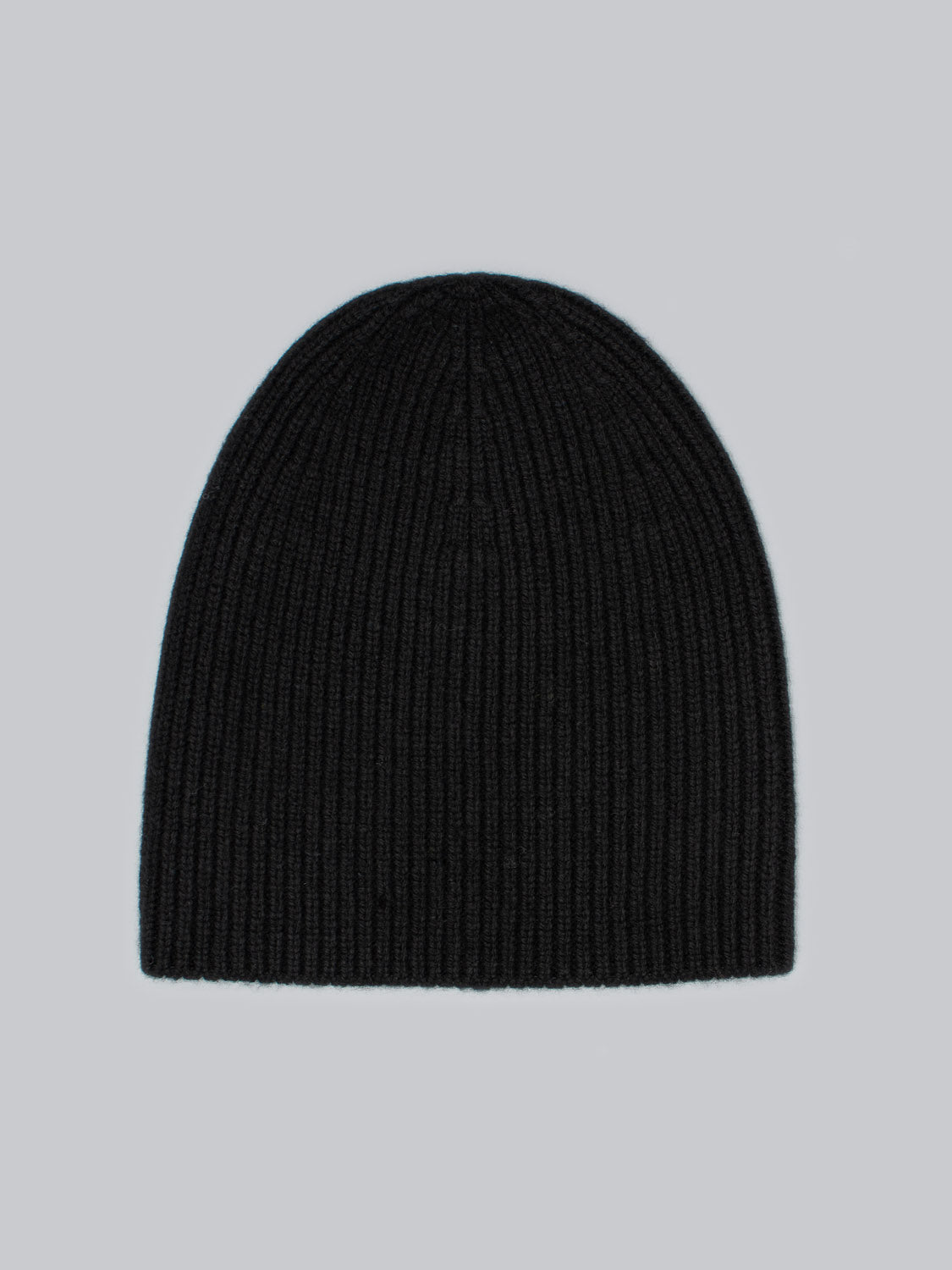 The ID Menswear Chamonix Wool Beanie, made from 100% wool, provides natural insulation against the cold. Set in black on a light gray background, this ribbed knit beanie is both stylish and functional for any chilly adventure.