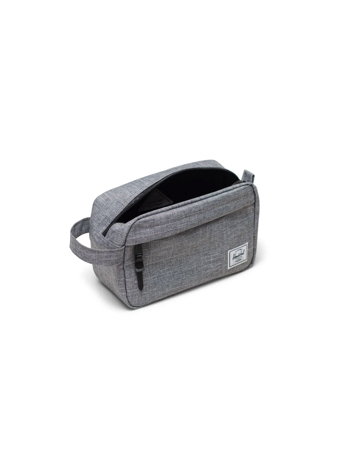The Herschel Chapter Travel Kit - 5L is a gray fabric toiletry bag with a waterproof zipper, side handle, and front pocket with a white rectangular label. Its black interior makes it perfect for organizing essentials on the go.