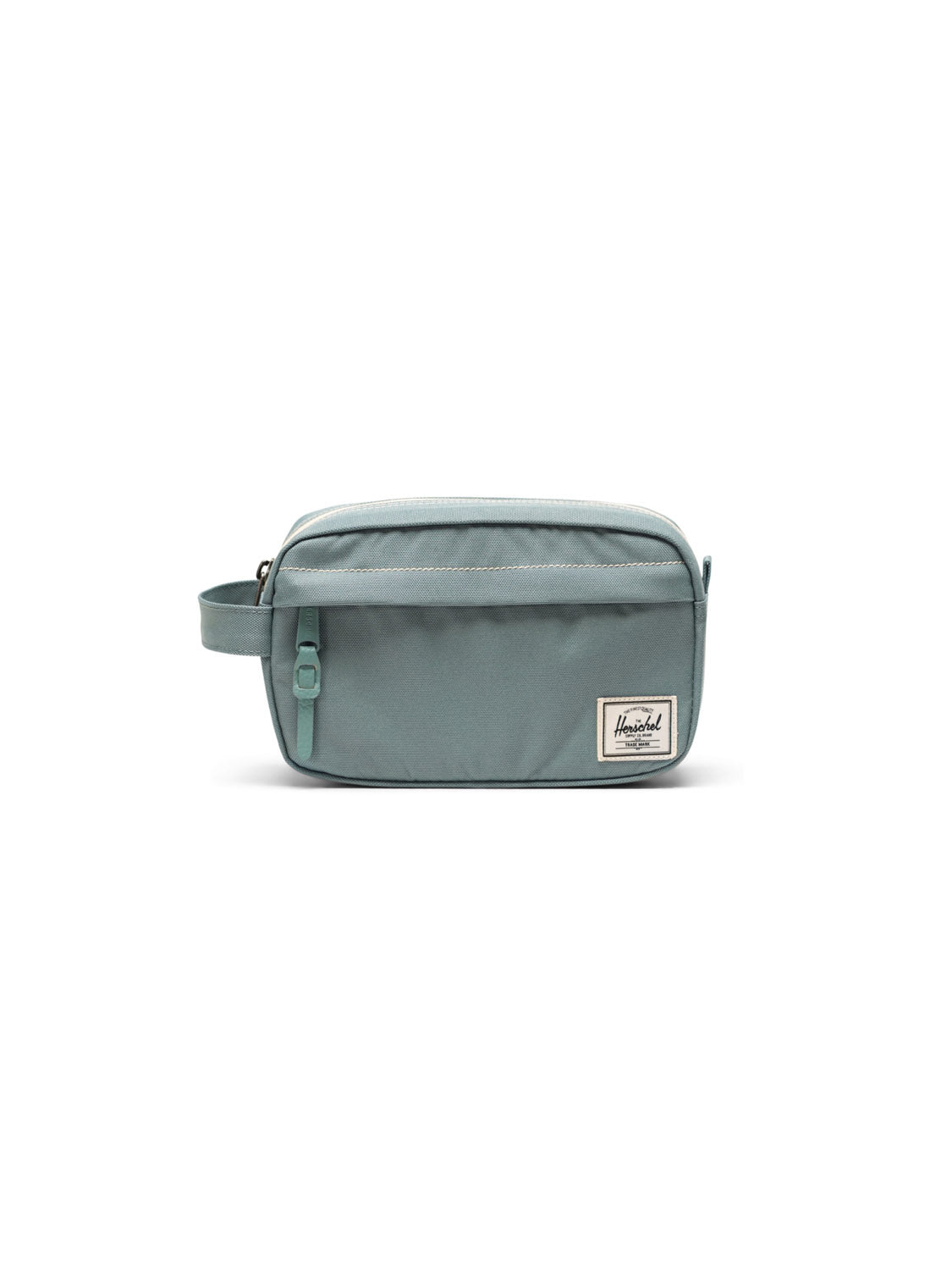 The Herschel Chapter Small Travel Kit is a light blue rectangular toiletry bag with a side handle, zipper closure, and white front label, shown against a white background.
