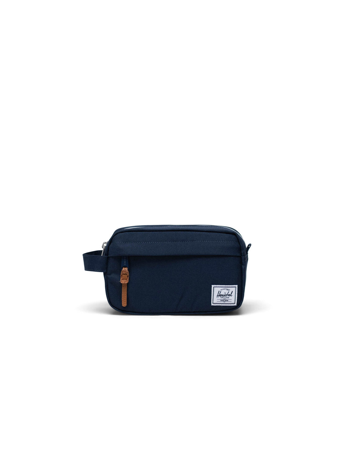 The Herschel Chapter Small Travel Kit is a navy blue toiletry bag featuring a brown leather zipper pull, side handle, and white rectangular Herschel logo patch on the front pocket, shown on a white background.