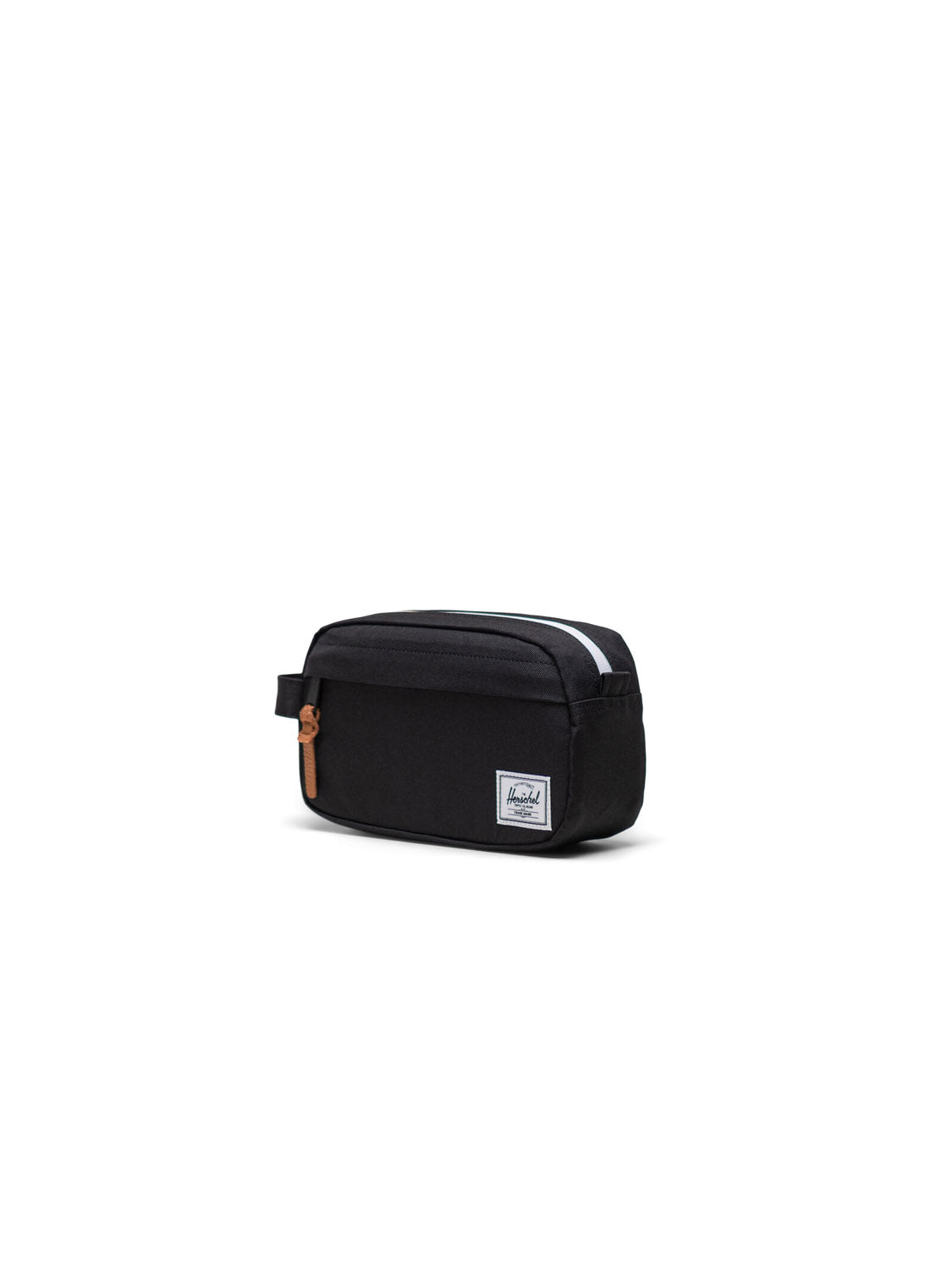 The Herschel Chapter Small Travel Kit is a black toiletry organizer with a front zipper pocket, side handle, tan zipper pull, and a white rectangular logo patch on the front, shown against a plain white background.