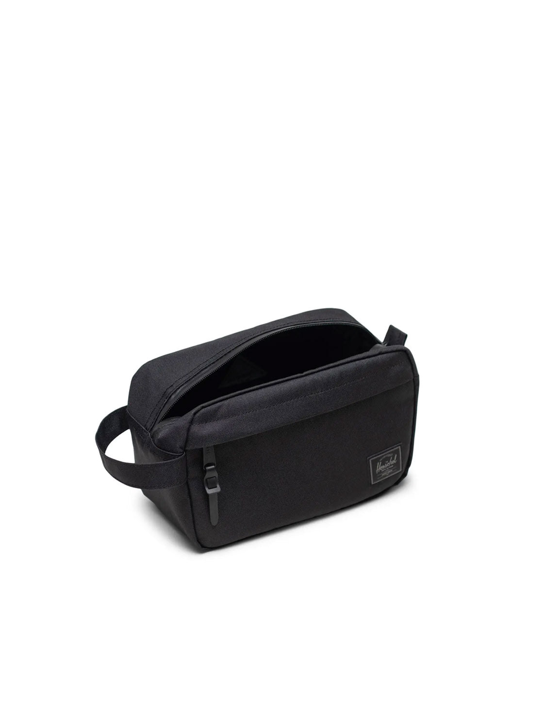 The Herschel Chapter Travel Kit is a black rectangular toiletry bag with a side handle, waterproof zipper, small front pocket, and front label, shown on a plain white background.