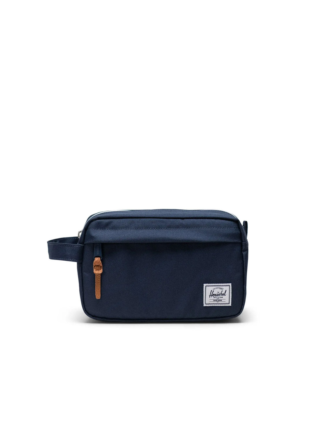 The Herschel Chapter Travel Kit is a navy blue rectangular toiletry bag with a side handle, front zip pocket with waterproof zipper and tan pull tab, plus a white Herschel label—ideal as a compact organizer or travel kit.