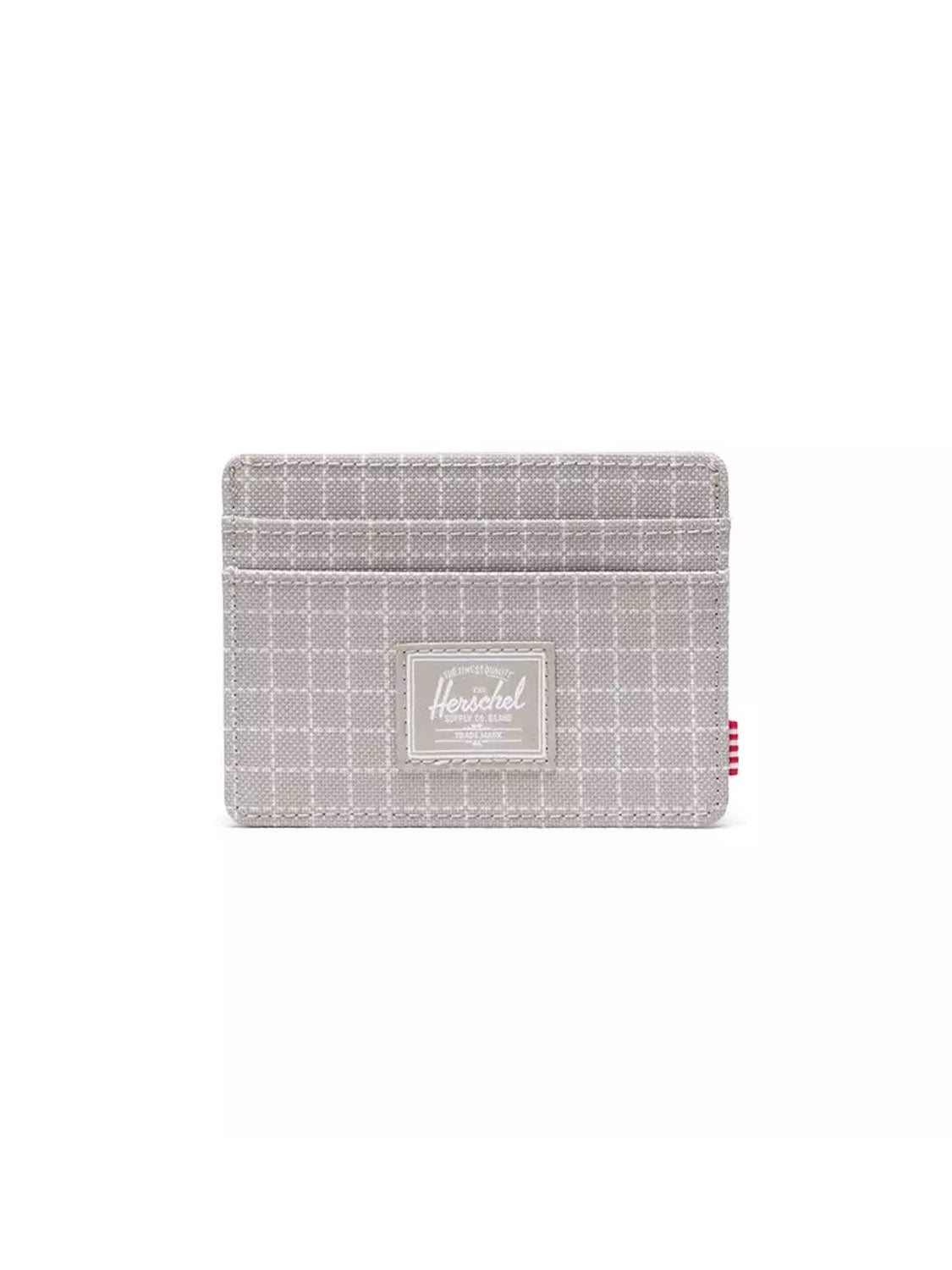The Herschel Charlie Cardholder Wallet is a light gray compact wallet with a subtle white checkered pattern, multiple card slots, the Herschel logo patch on the front, and a small red-and-white striped tag on the right side.