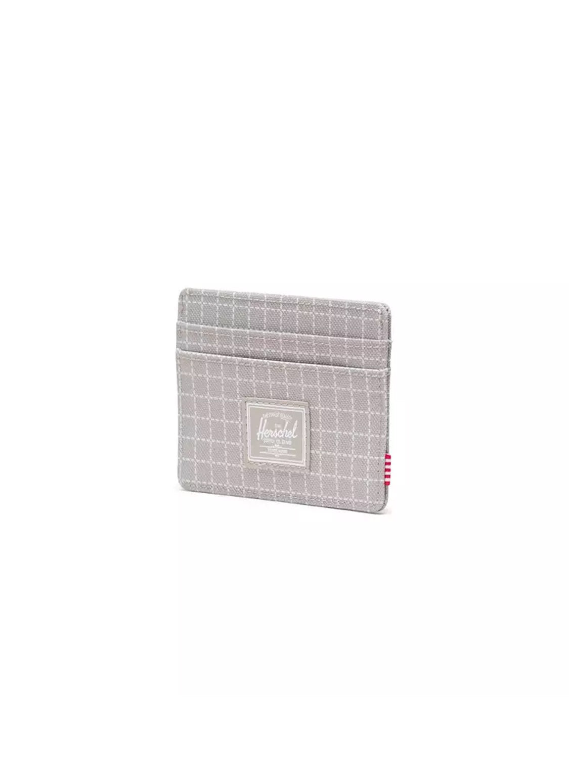 The Herschel Charlie Cardholder Wallet is a light grey, compact holder with a white checkered pattern, RFID blocking, and a front logo patch, shown against a plain white background.