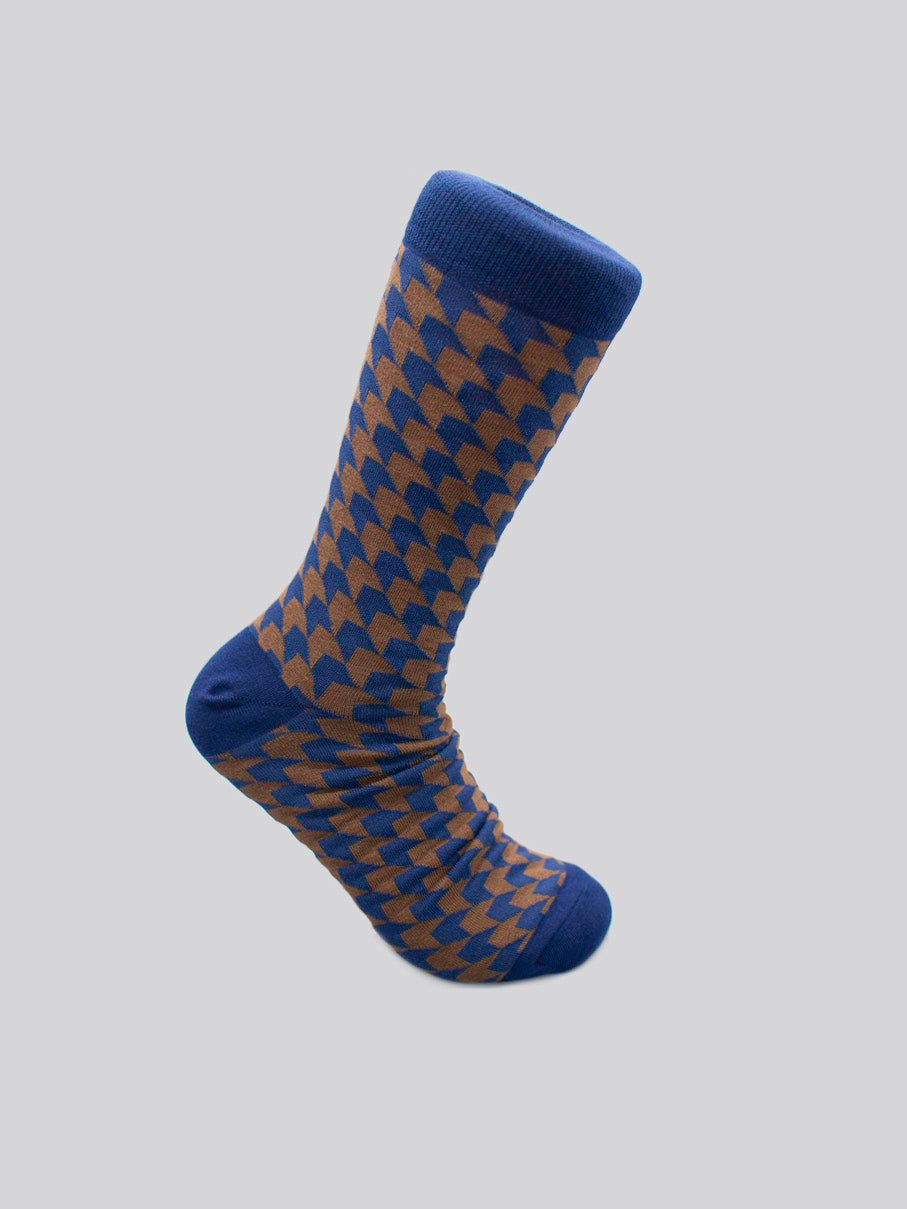 Check Graphic Socks by ID Menswear: a single combed cotton sock with a brown and blue houndstooth pattern, solid blue toe, heel, and cuff, fits men’s shoe size 8-12. Shown on a light gray background.