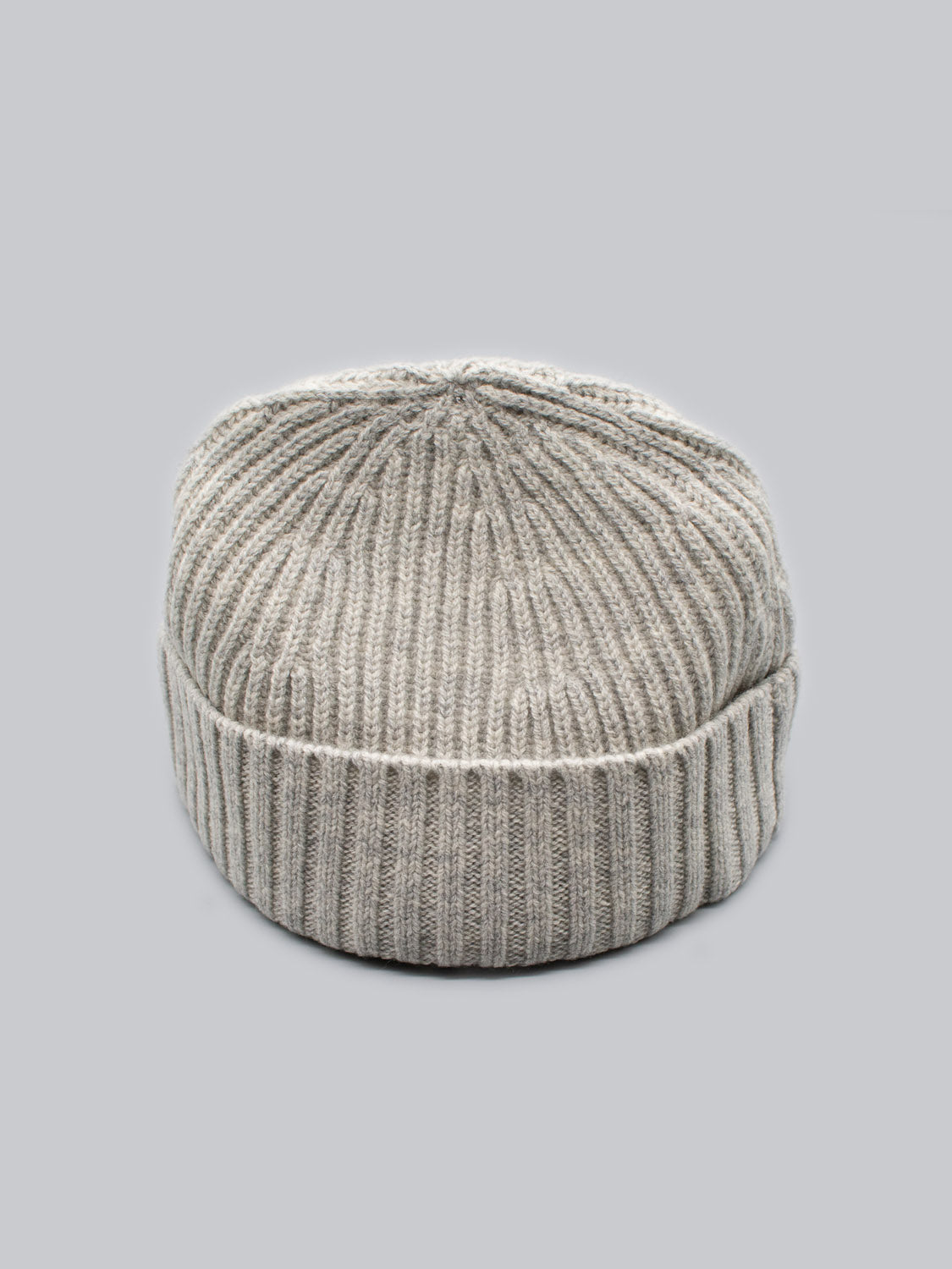 The Cho Oyu Merino Wool Fishermans Beanie by ID Menswear: a gray, ribbed, knit beanie with a classic fisherman style and folded bottom, set against a plain light gray background.
