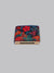 A folded ID Menswear Liberty™ Ciara Pocket Square in vibrant red, pink, and teal floral Tana Lawn cotton rests in a brown holder labeled POCKET SQUARE, set against a light gray background.