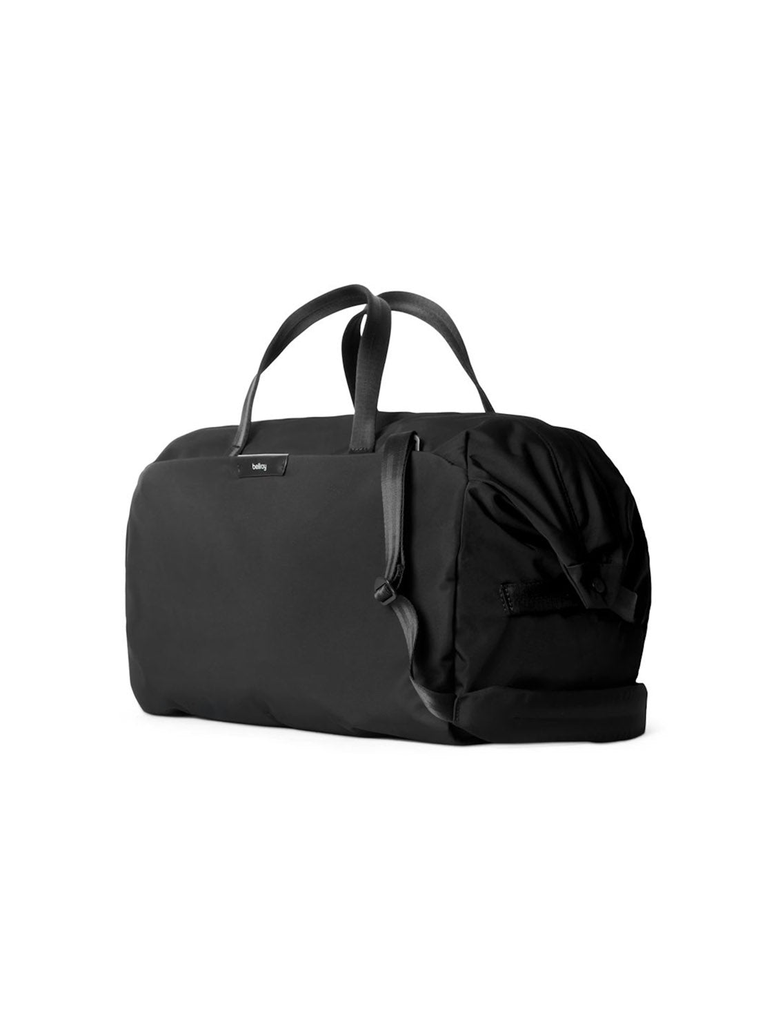 The Bellroy Classic Weekender Duffle Bag - 45L in black features short carry handles, a zipper closure, side pocket, and luggage pass-through for easy airport travel. Shown against a plain white background.
