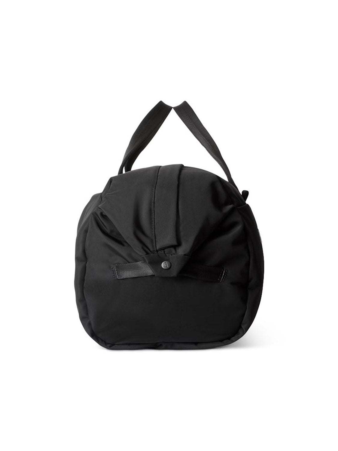 The Bellroy Classic Weekender Duffle Bag - 45L is a black, round packable barrel bag with short handles and a front flap secured by a buttoned strap, shown against a plain white background.