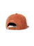 The Katin Cortex Hat is a rust-colored cotton corduroy hat featuring an adjustable brown plastic strap at the back and small white embroidered text above the opening.