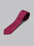 A handmade, rolled-up ID Menswear Egyptian Firefinch Cotton Tie in solid magenta is displayed on a plain light gray background.