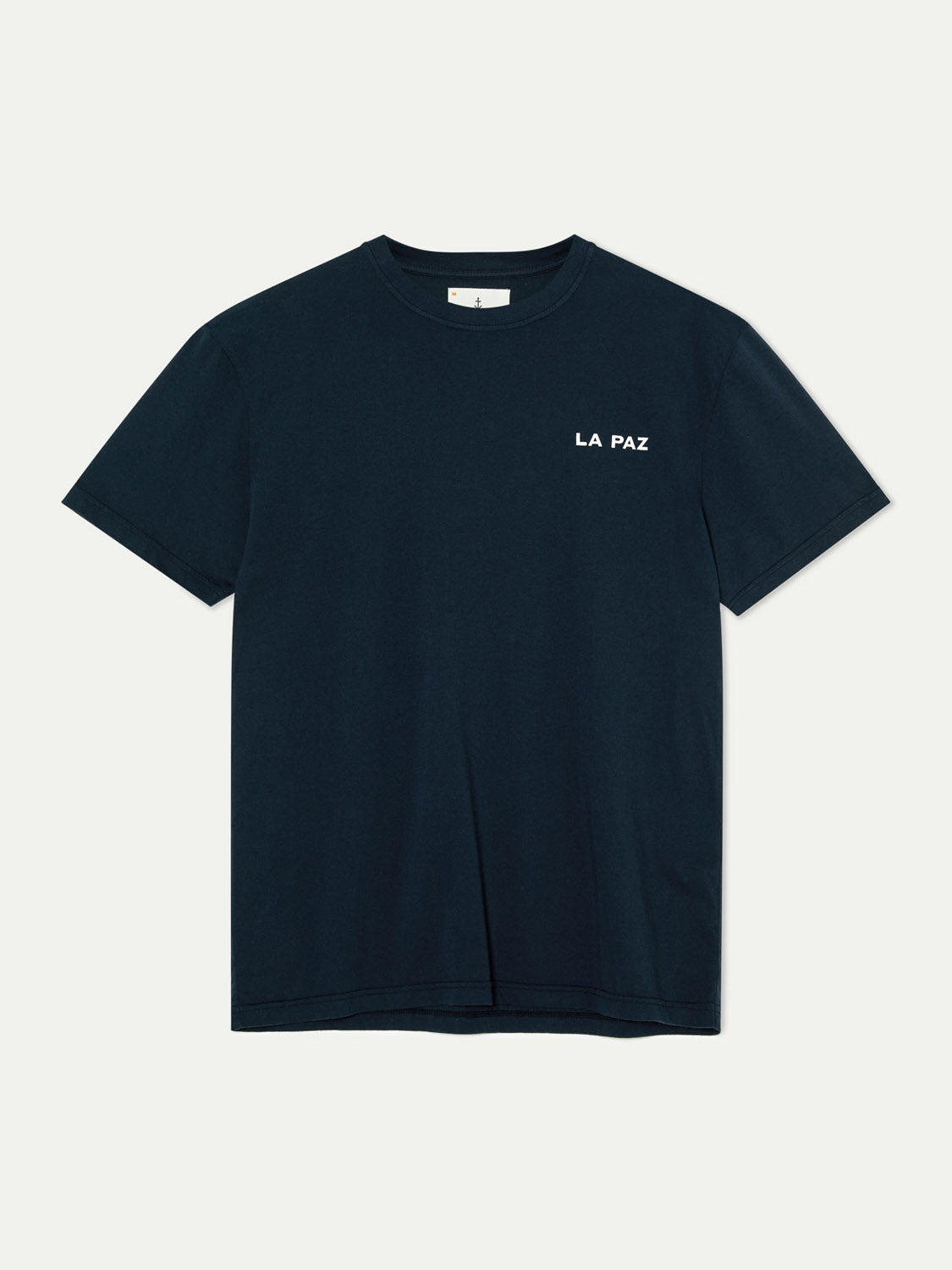 The La Paz Dantas Boat Tee is an eco-friendly, dark blue T-shirt with LA PAZ in white on the left chest, shown against a light background.