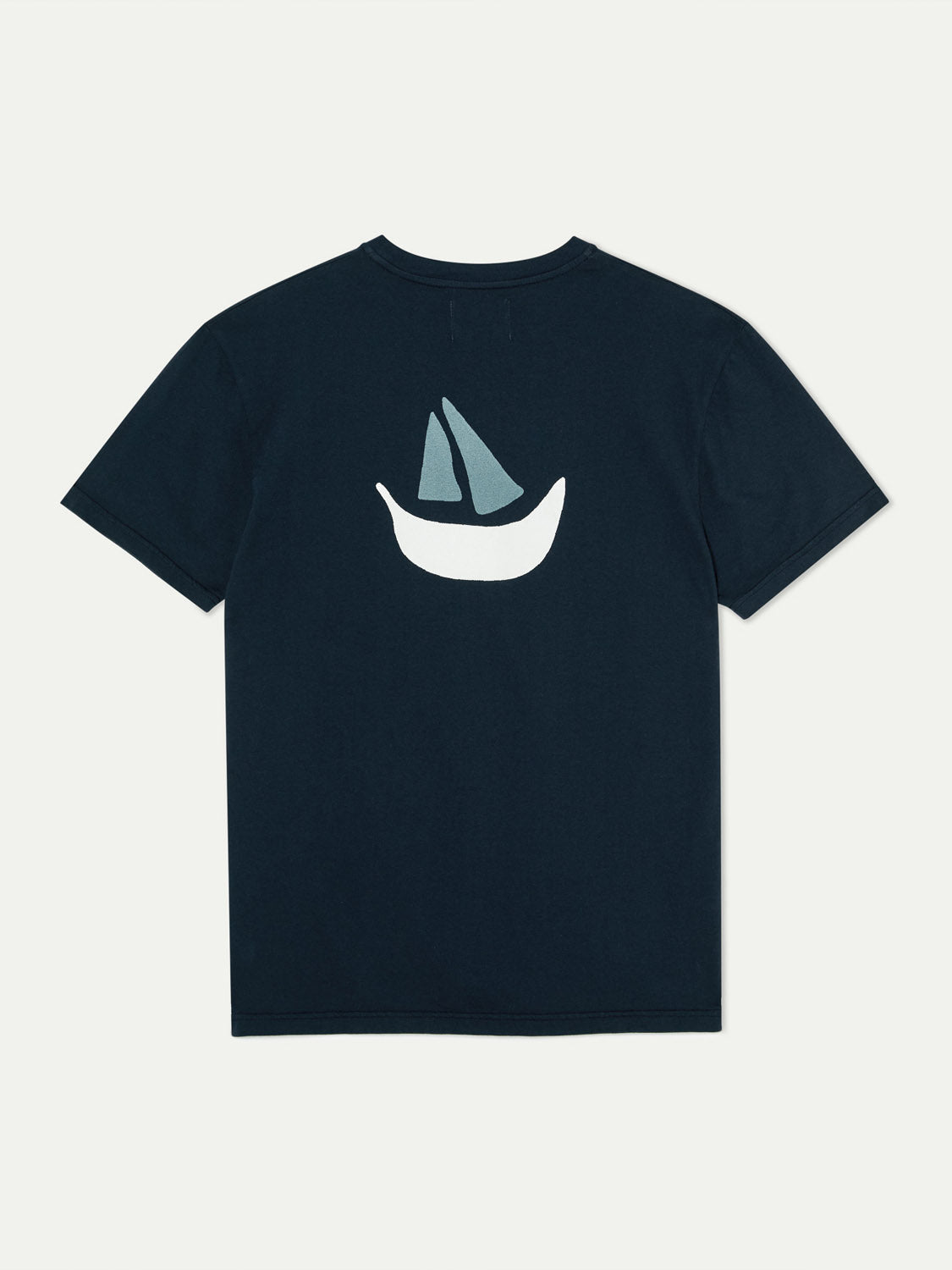 The La Paz Dantas Boat Tee is a black T-shirt made from 100% cotton, featuring a stylized white boat with gray sails printed on the back on a plain background.