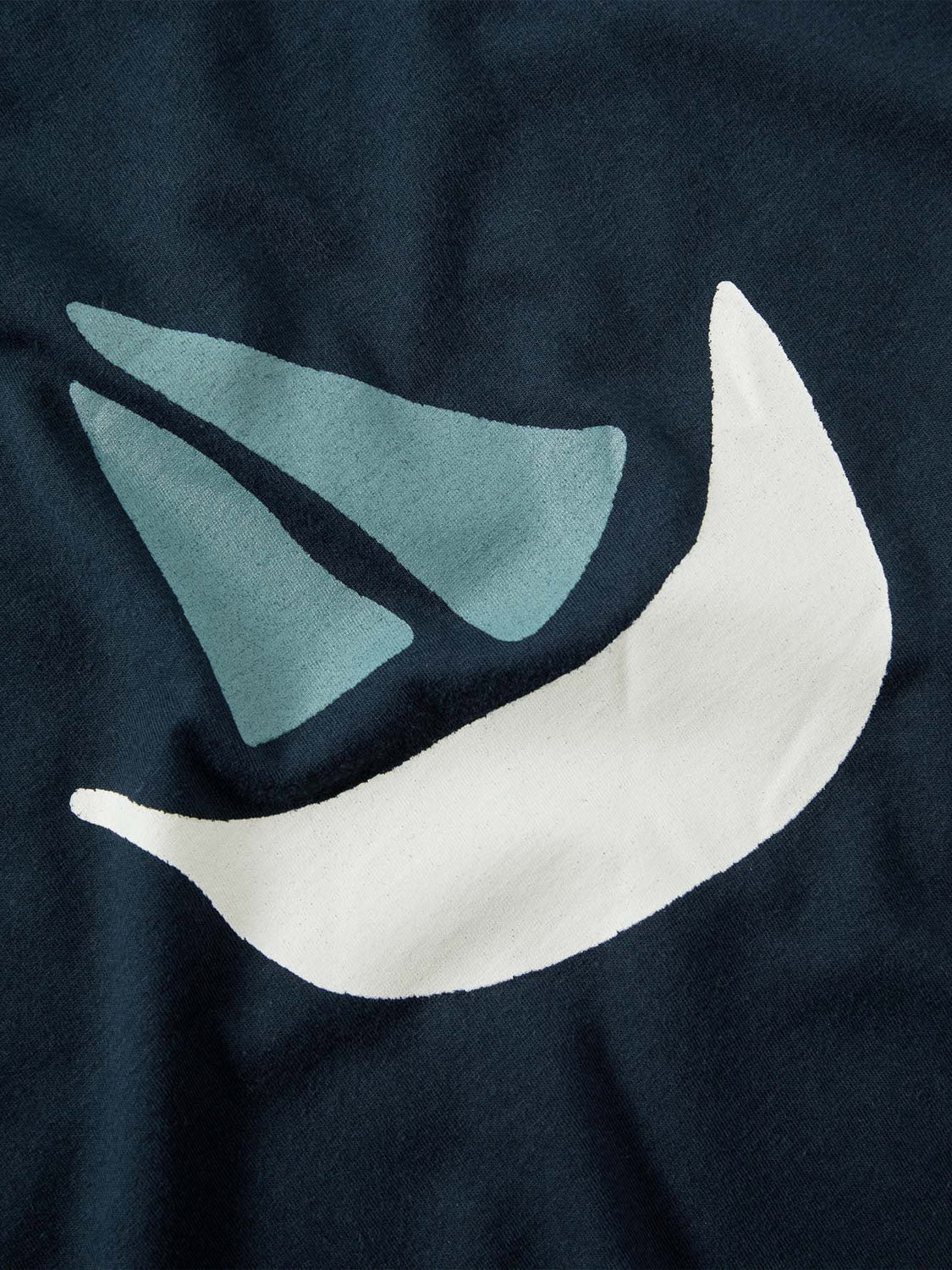 The La Paz Dantas Boat Tee features an abstract design with two light blue triangles and a white crescent on a dark background, evoking the softness of 100% cotton.