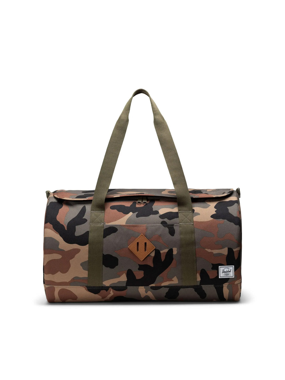 The Herschel Heritage™ Duffle - 40L is a cylindrical travel bag with green handles and a brown, green, and black camouflage print. Made from recycled polyester, it features a small white Herschel label on the lower right front.