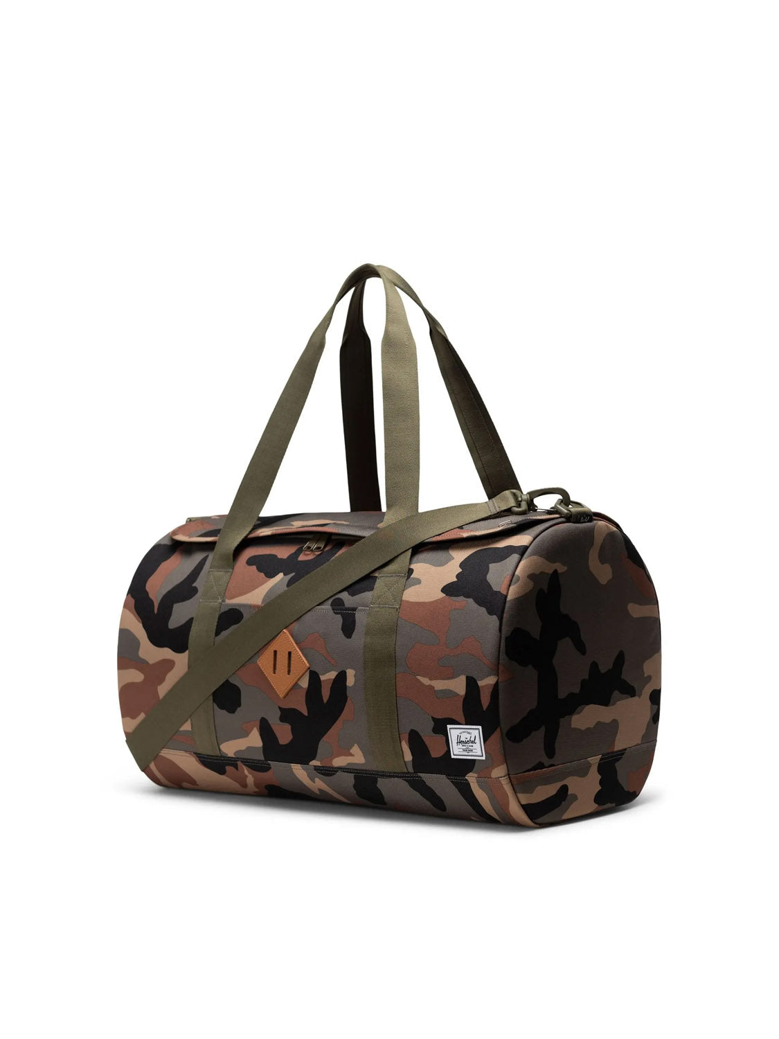 The Herschel Heritage™ Duffle - 40L is a cylindrical travel bag featuring a green and brown camo pattern, olive green straps, and a white Herschel logo patch—made from recycled polyester for eco-friendly adventures.