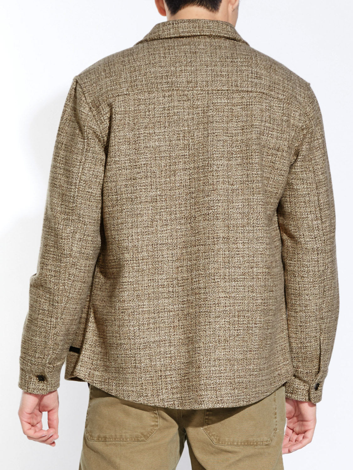 A person is shown from the back wearing the Civil Society Durbin Relaxed Fit Shirt Jacket with a collar and buttoned cuffs, paired with light brown pants for a casual, relaxed look.