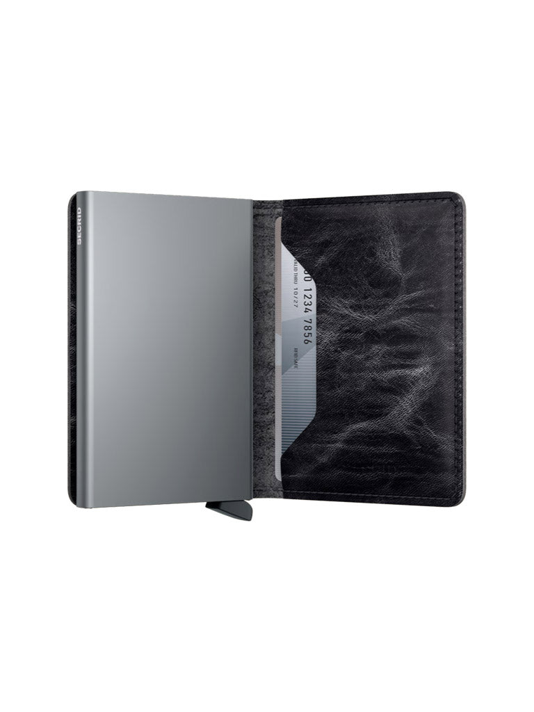 The Secrid Slimwallet Dutch Martin is a slim, open black leather wallet with RFID protection and a gray interior, featuring a partially visible credit card and a metallic section, set against a plain white background.