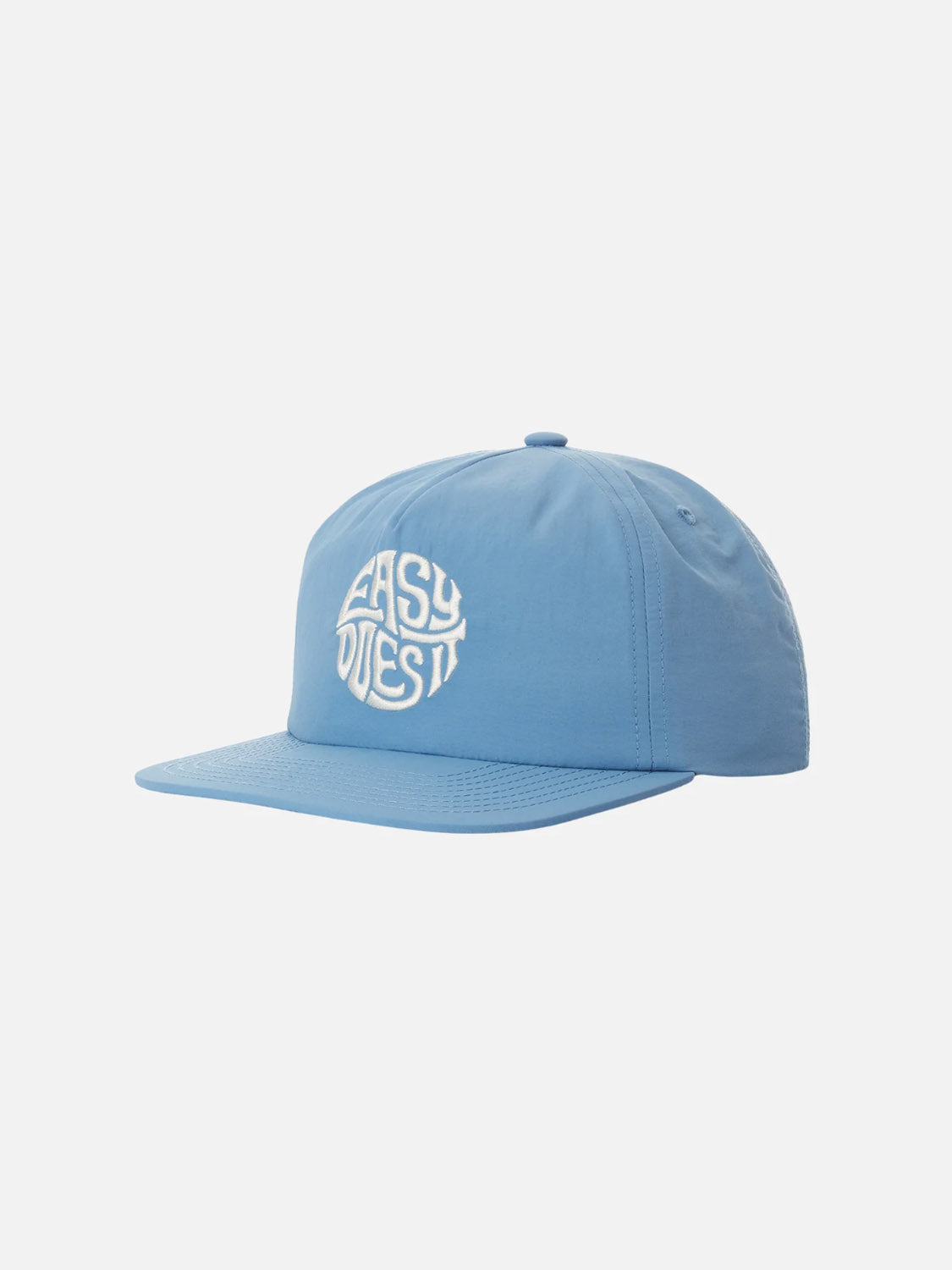 The Katin Easy Emblem Hat in light blue features a flat brim and custom embroidery. A white circular logo with stylized text on the off-white front adds a sleek, modern touch to this headwear piece from Katin.