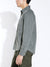 A person in profile wears the Civil Society Ernst Relaxed Fit Long Sleeve Shirt in olive green with a chest pocket and matching pants, evoking classic American workwear style against a plain white background.