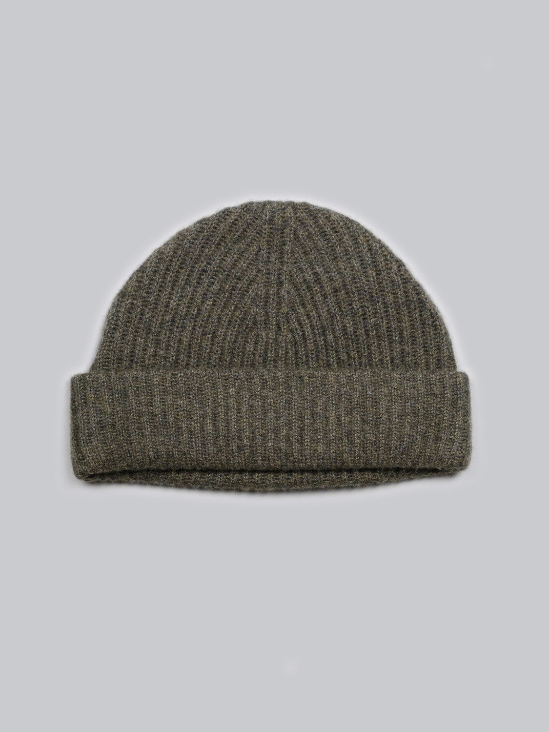 The Everest Cashmere Beanie by ID Menswear features a ribbed olive green design with a folded brim, shown flat on a light grey background—this lightweight accessory is ideal for versatile style.