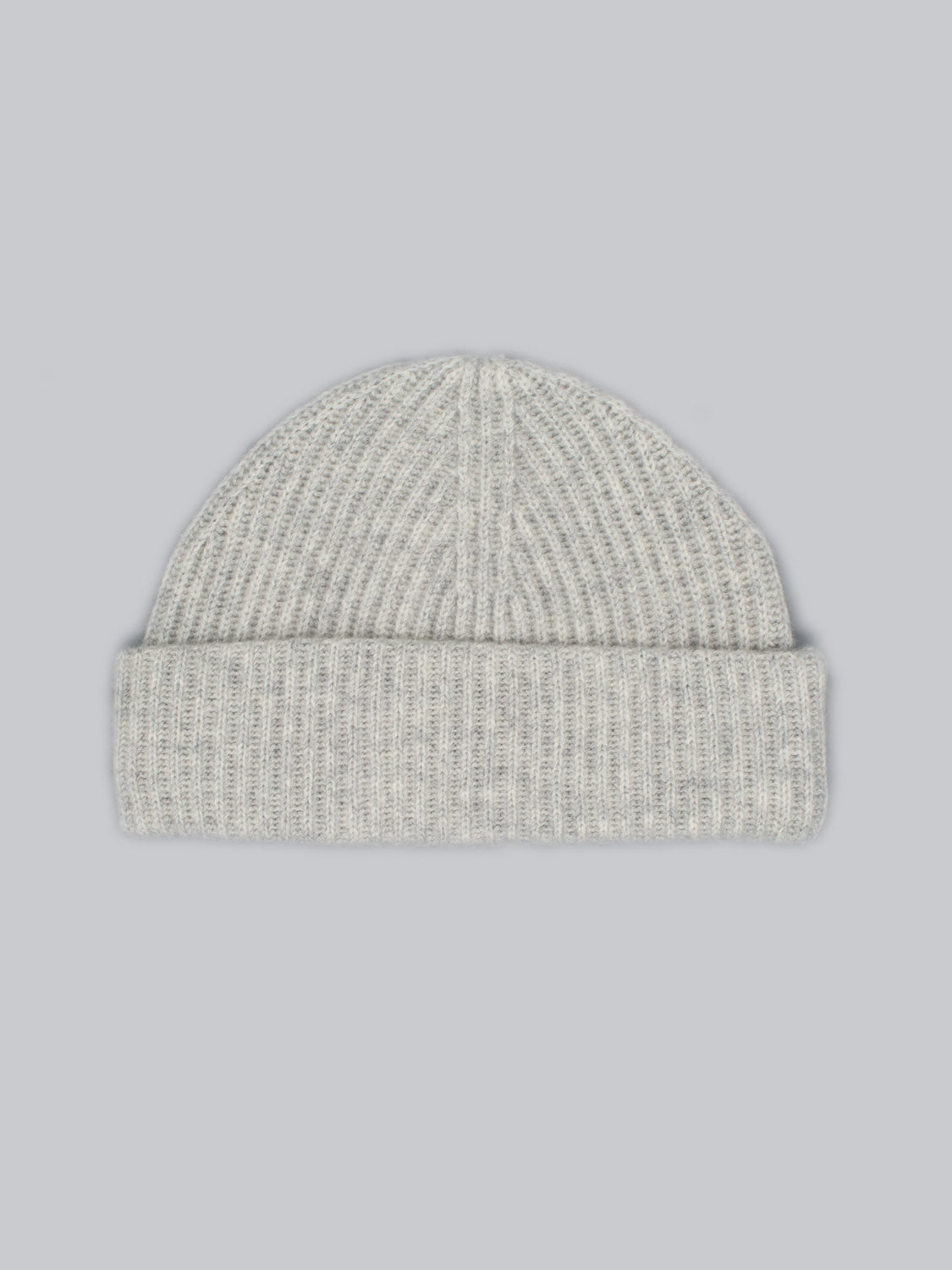The Everest Cashmere Beanie by ID Menswear is a light grey, ribbed cashmere beanie with a folded brim, shown against a plain light grey background.