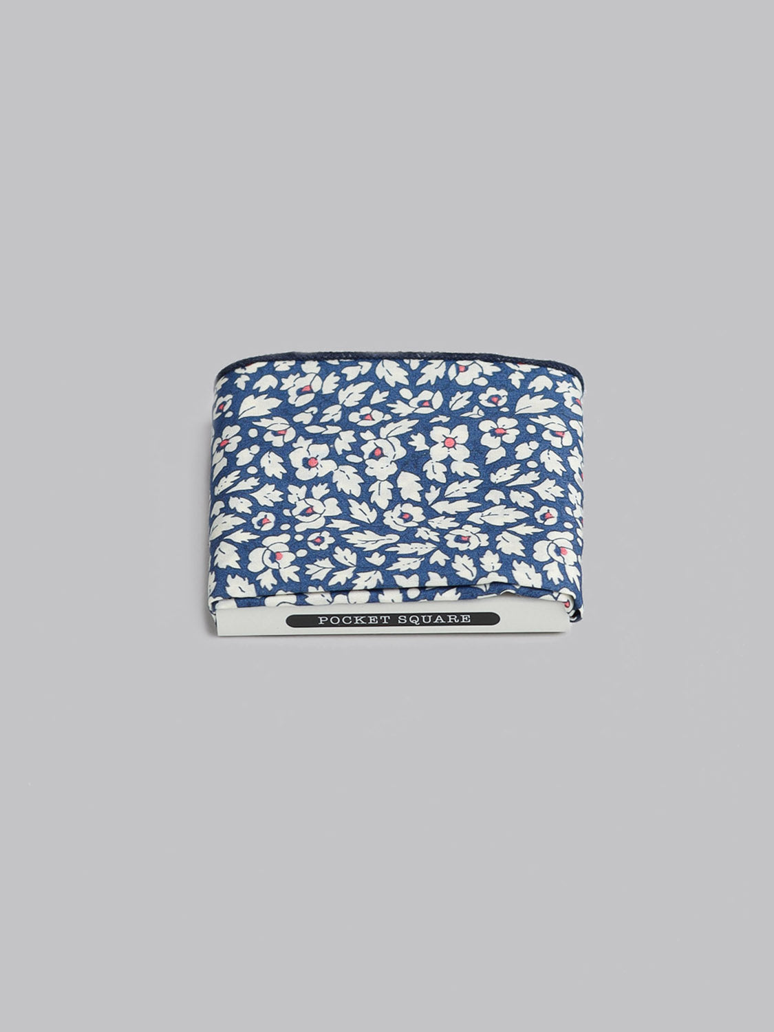 The Liberty™ Feather Pocket Square by ID Menswear features a blue base with white and red florals in soft Tana Lawn cotton, shown on a light gray background.