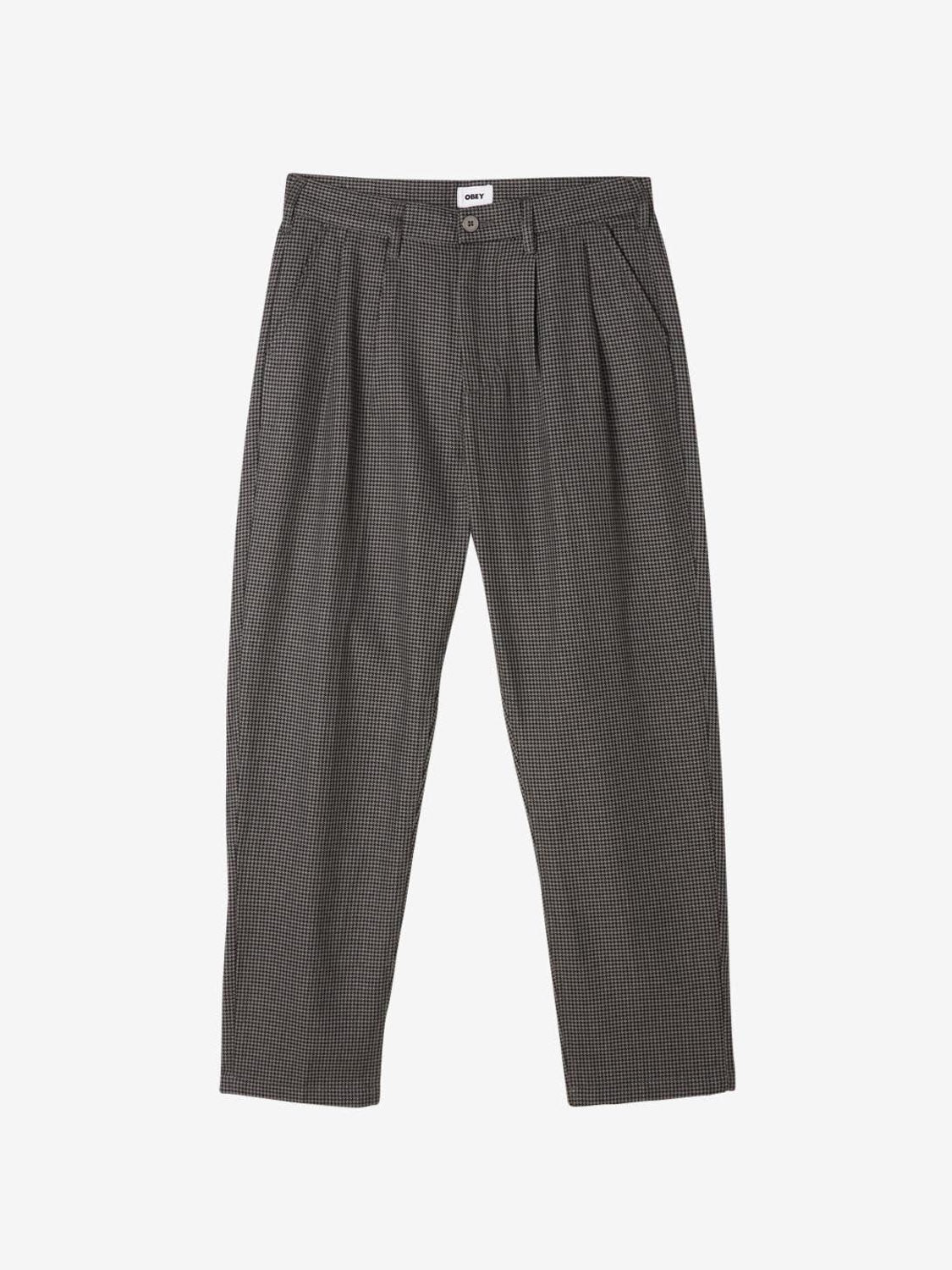 The Obey Fubar Houndstooth Pleated Pant by Obey features a high-waisted, relaxed fit in dark gray with a subtle checkered pattern, front pleats, and side pockets, shown flat on a white background.