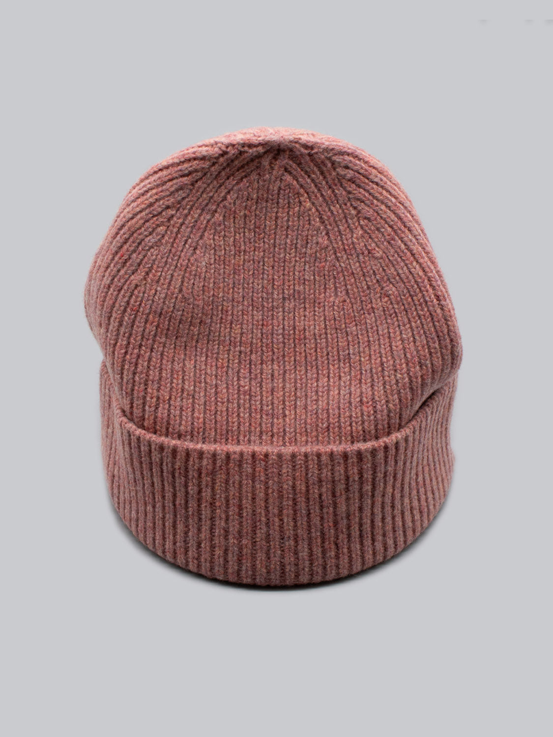 A close-up of the Fuji Merino Wool Beanie by ID Menswear, featuring a folded brim and ribbed texture, set against a plain gray background as the perfect winter companion.