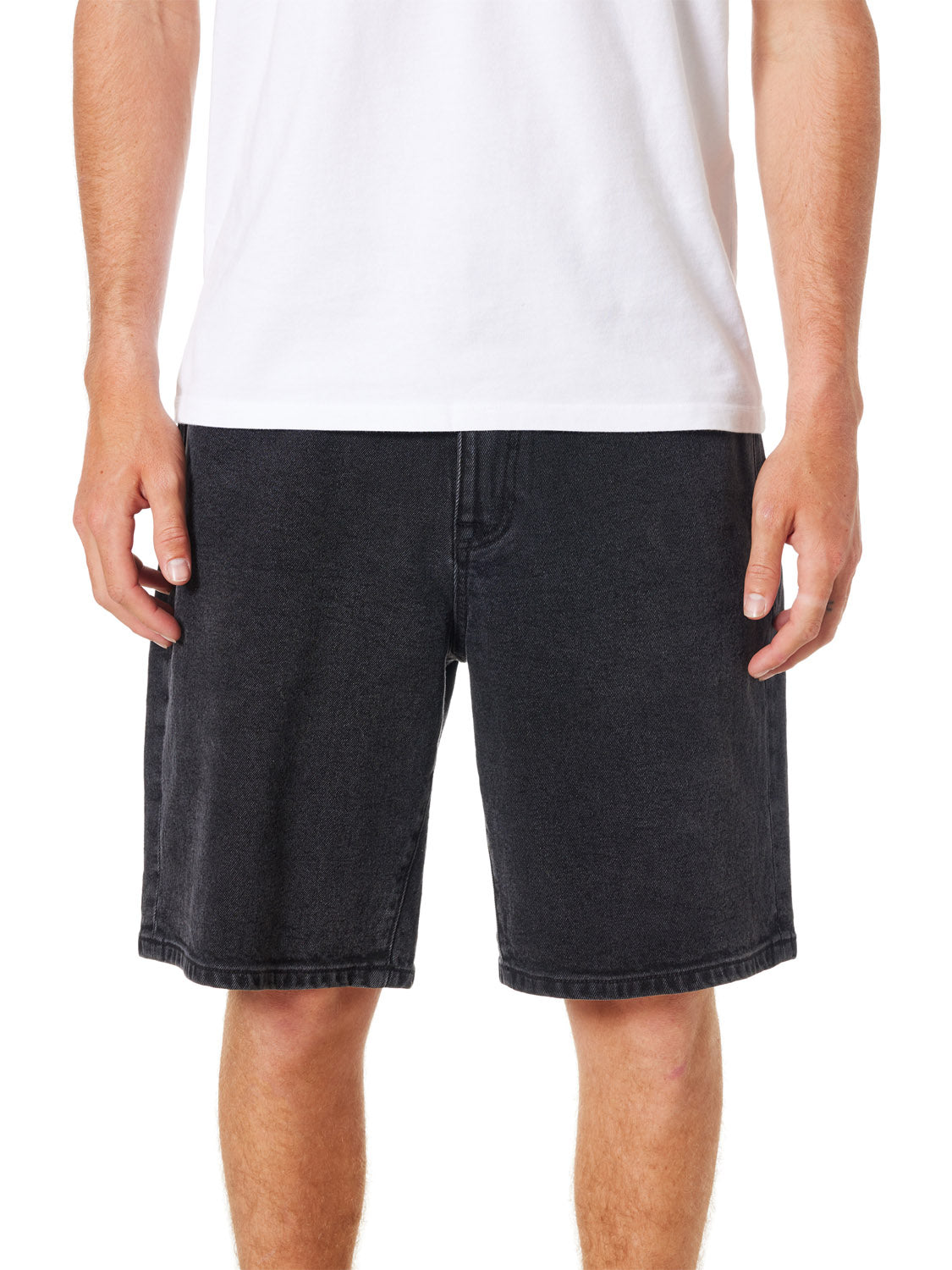 A person wearing a white t-shirt and Katins George 64 Short - 20 in a classic wash stands against a plain background. Their arms are relaxed at their sides, and their legs are visible from the knees down, highlighting the relaxed fit of their attire.